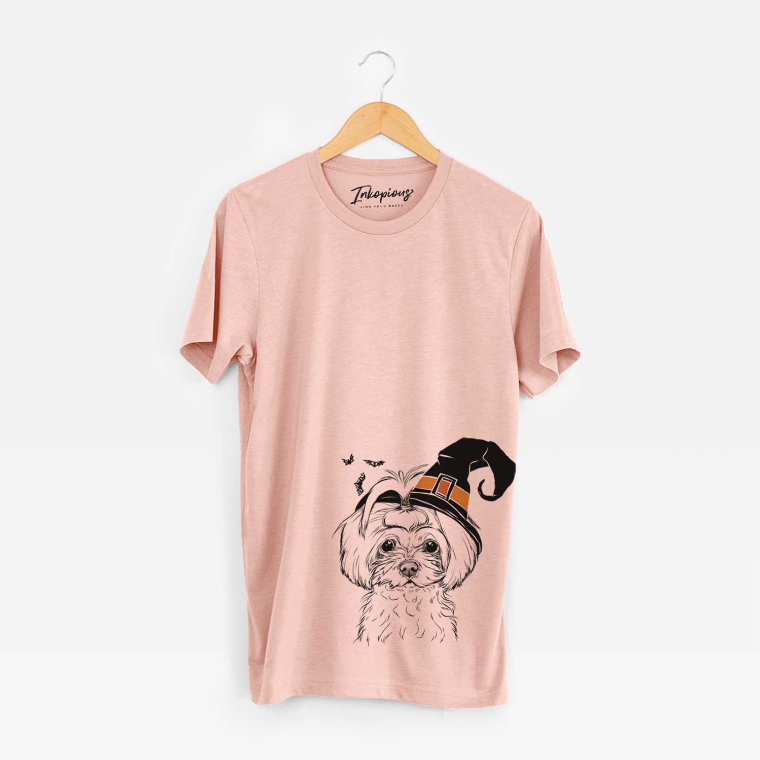 Hand-drawn sketch of Ellie the Maltese wearing a witch hat on a Peach Unisex crewneck