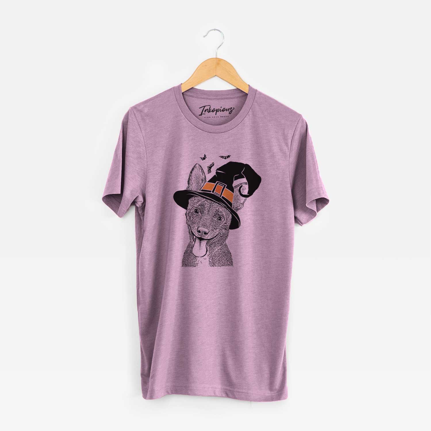 Hand-drawn sketch of Elvira the Terrier Mix wearing a witch hat on an Orchid Unisex crewneck