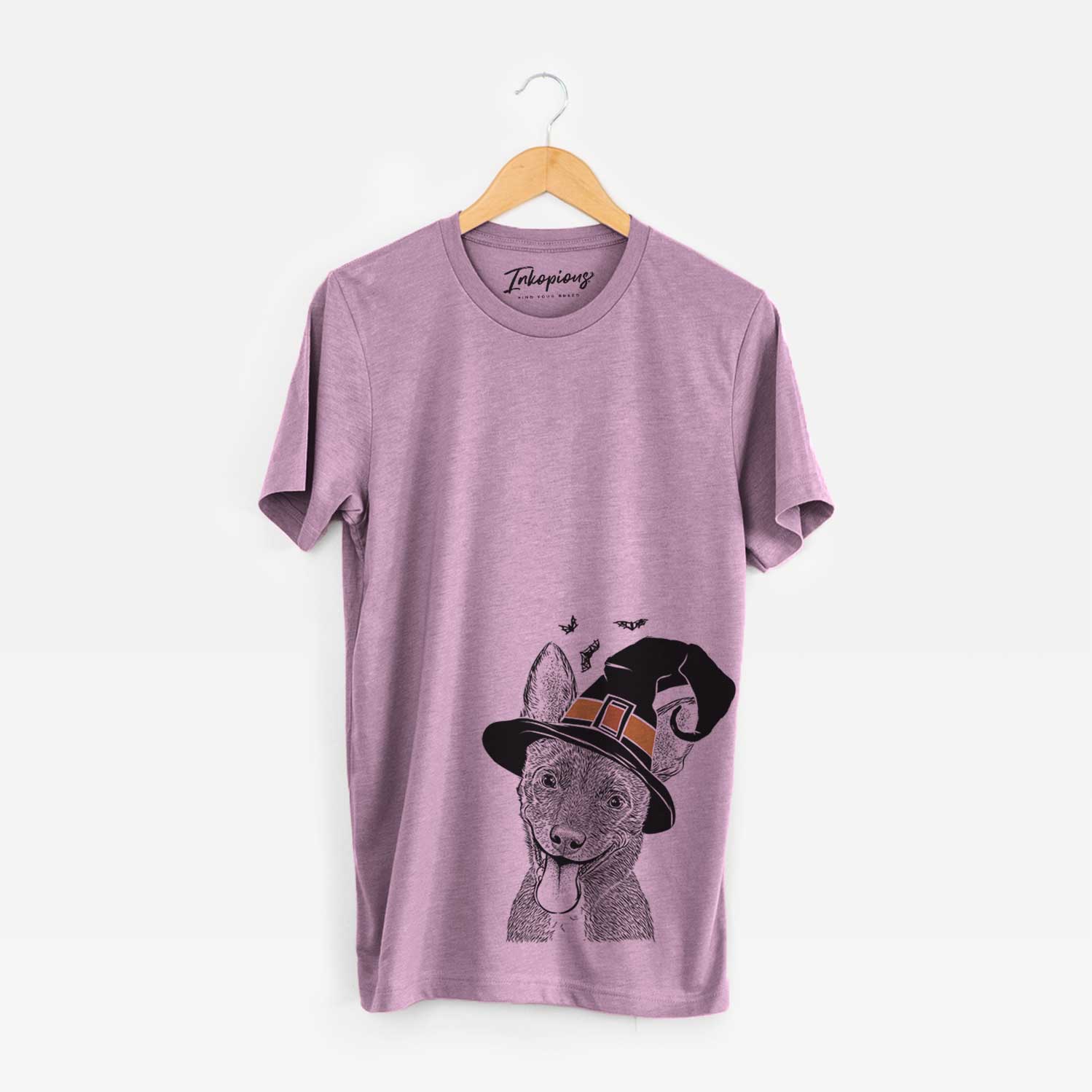 Hand-drawn sketch of Elvira the Terrier Mix wearing a witch hat on an Orchid Unisex crewneck