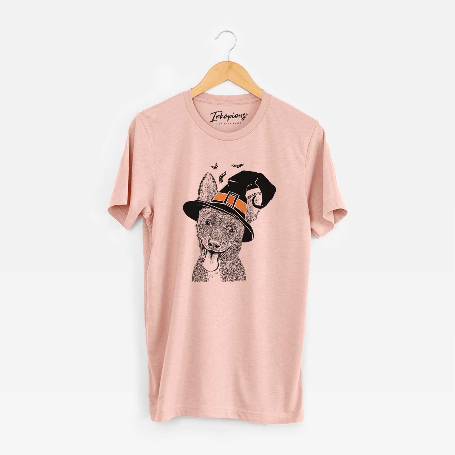 Hand-drawn sketch of Elvira the Terrier Mix wearing a witch hat on a Peach Unisex crewneck
