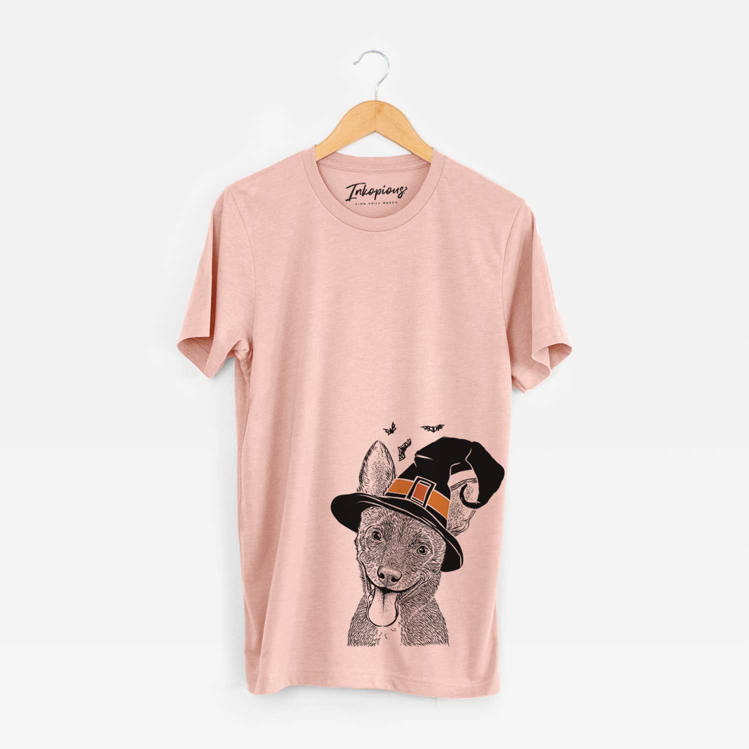 Hand-drawn sketch of Elvira the Terrier Mix wearing a witch hat on a Peach Unisex crewneck