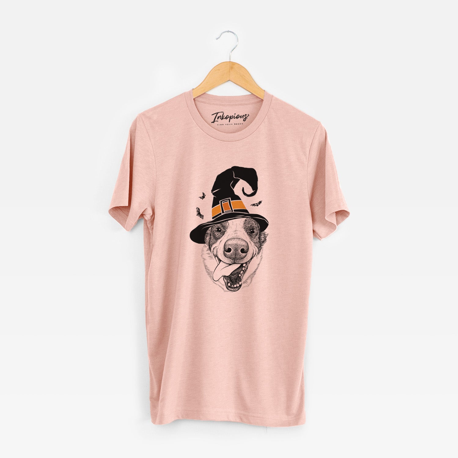 Hand-drawn sketch of Elwood the Border Collie wearing a witch hat on a Peach Unisex crewneck