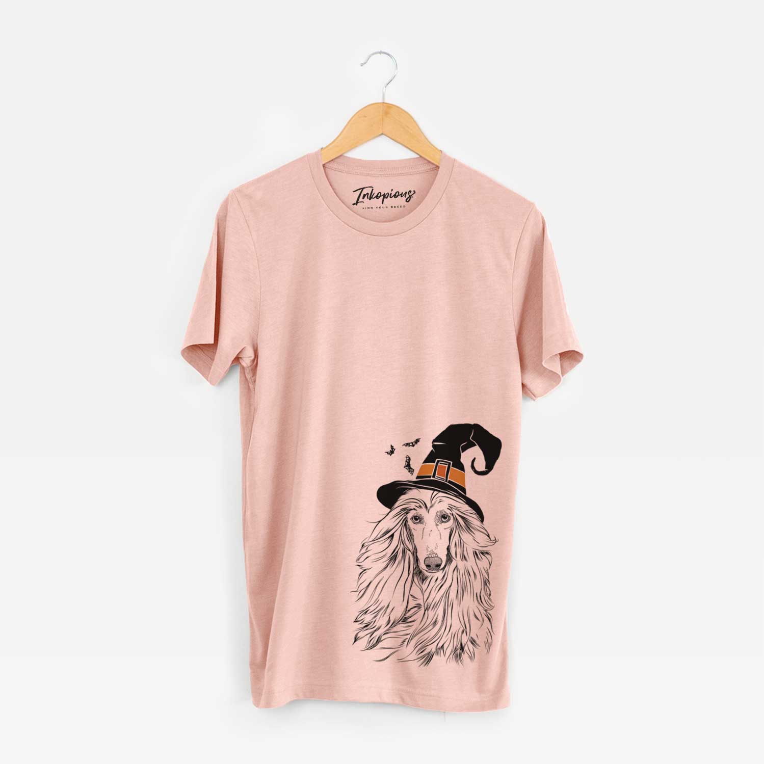 Hand-drawn sketch of Fabio the Afghan Hound wearing a witch hat on a Peach Unisex crewneck