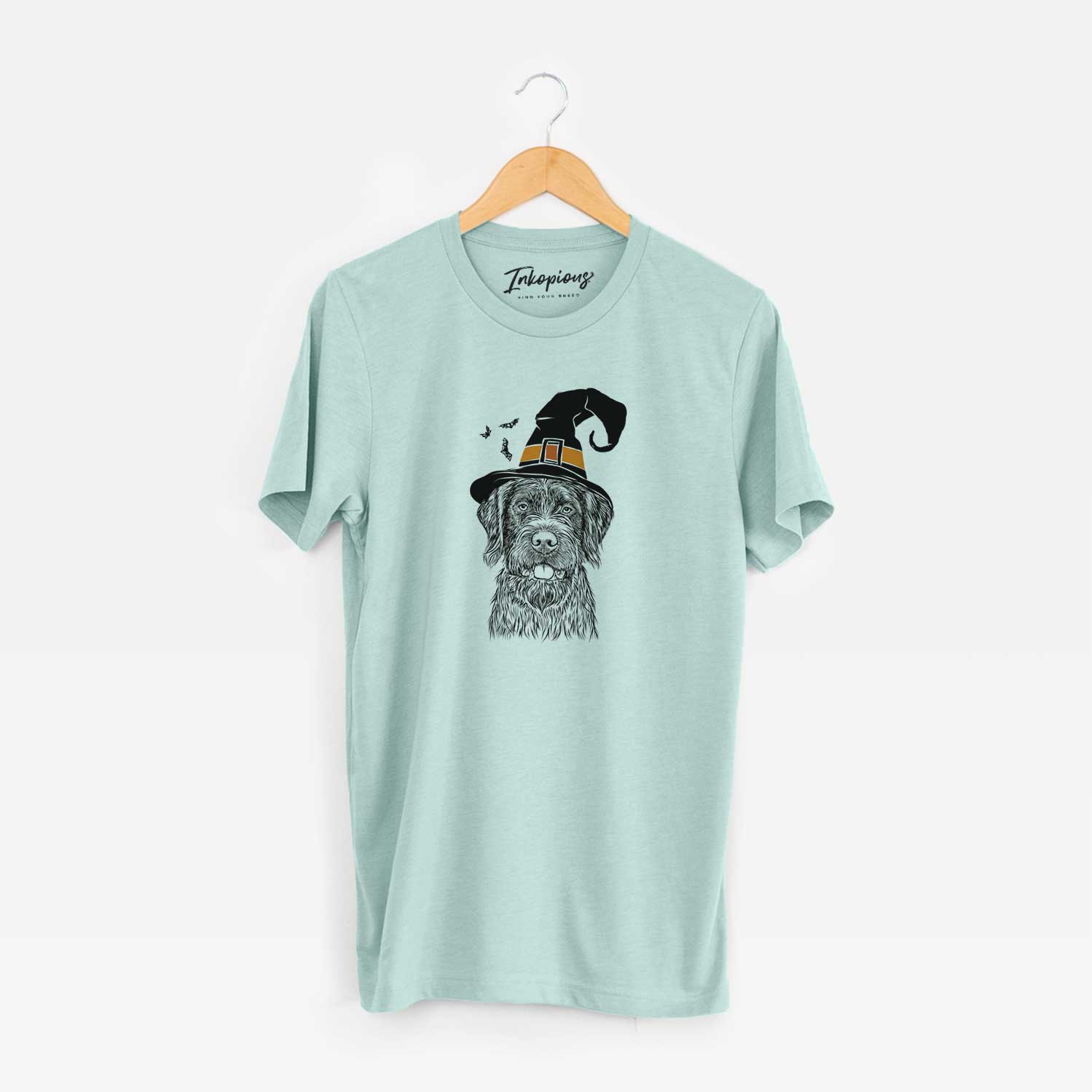 Hand-drawn sketch of Fletcher the Wirehaired Pointing Griffon wearing a witch hat on a Heather Sage Unisex crewneck
