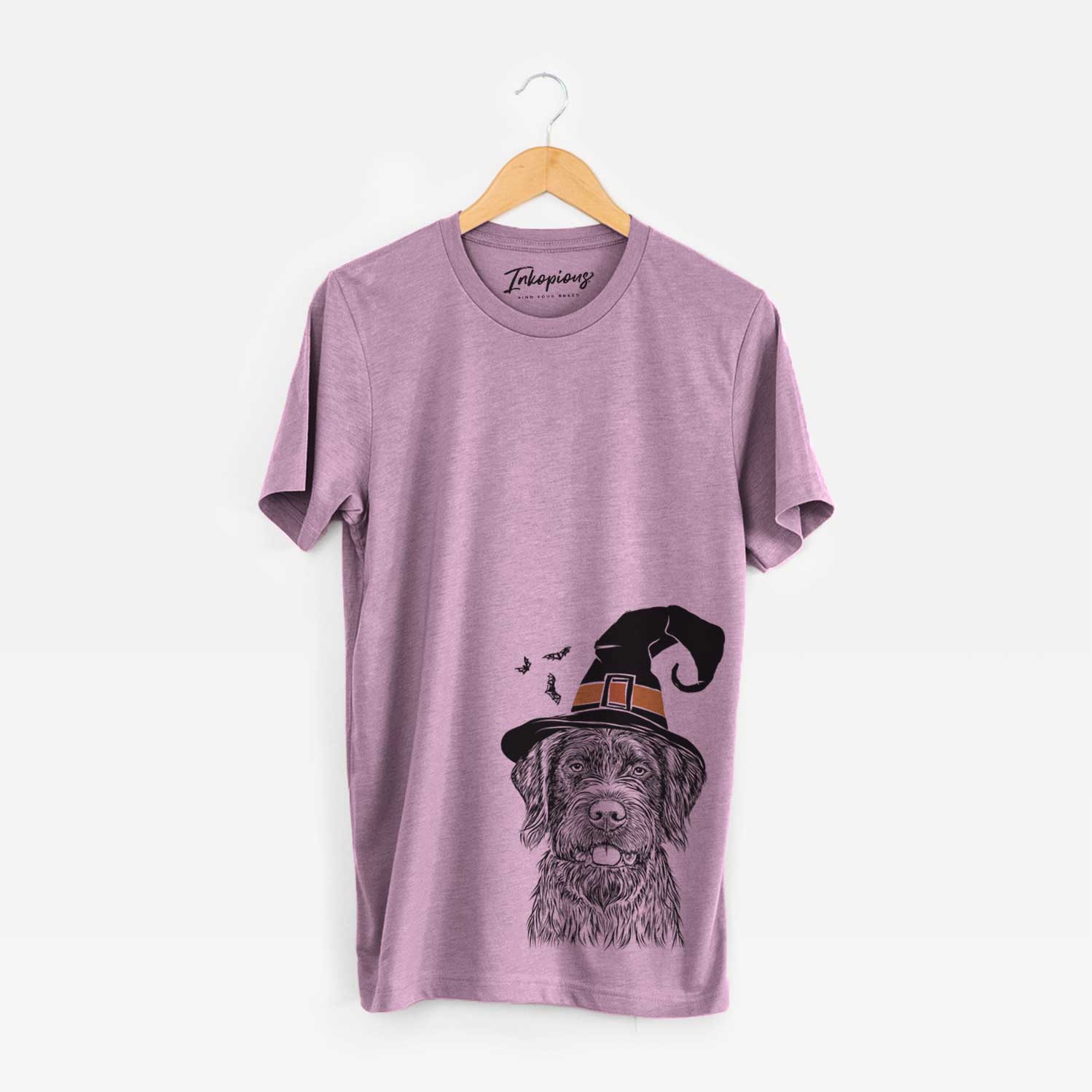Hand-drawn sketch of Fletcher the Wirehaired Pointing Griffon wearing a witch hat on an Orchid Unisex crewneck