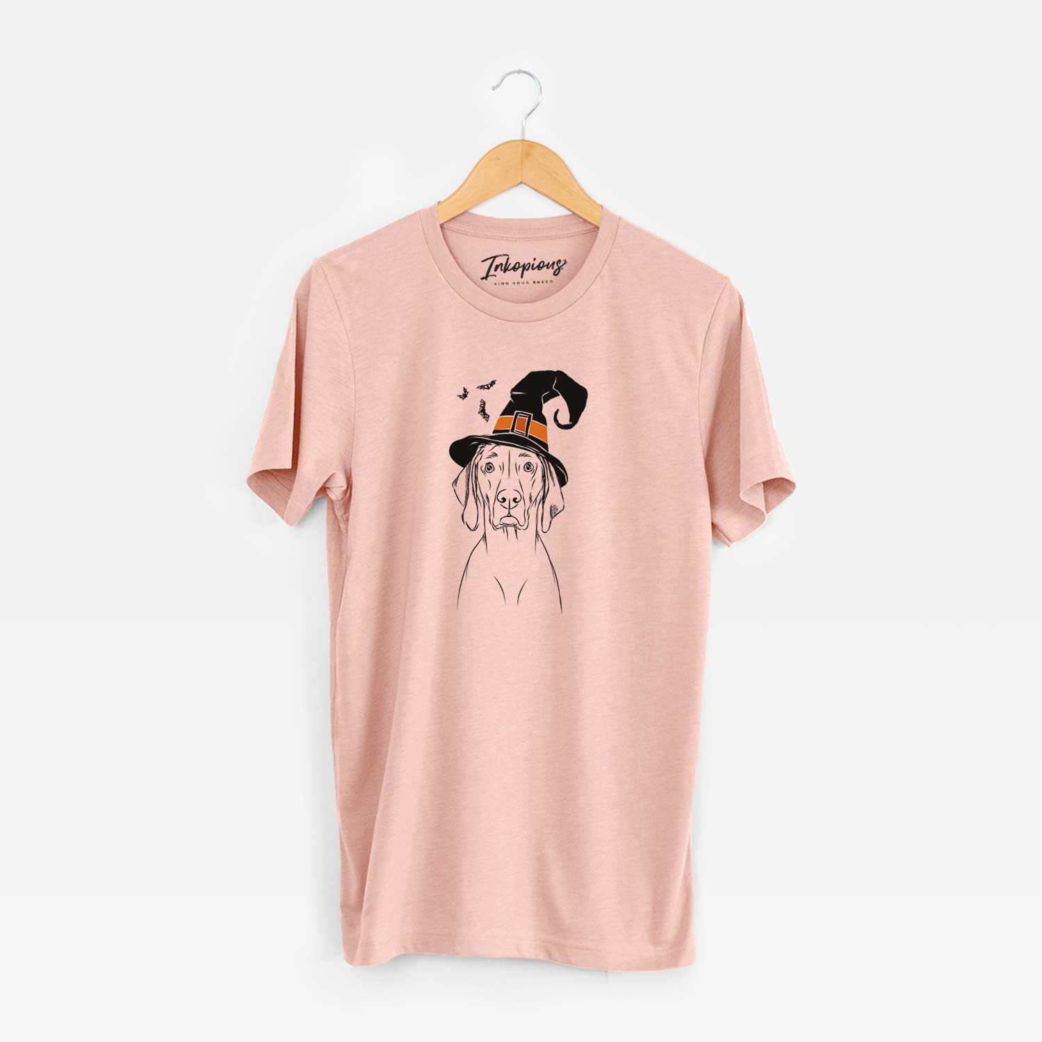 Hand-drawn sketch of Flint the Weimaraner wearing a witch hat on a Peach Unisex crewneck