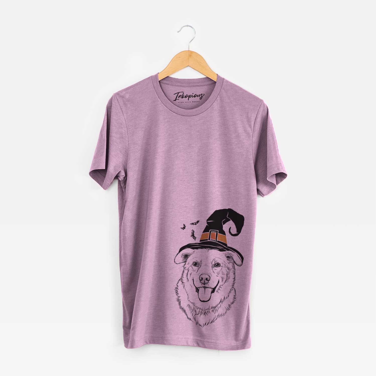 Hand-drawn sketch of Freeley the Mixed Breed wearing a witch hat on an Orchid Unisex crewneck
