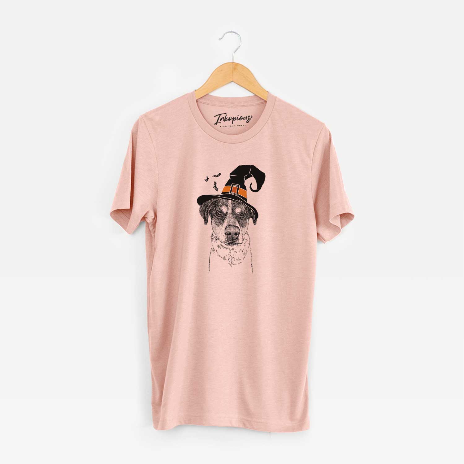 Hand-drawn sketch of Gertrude the Mixed Breed wearing a witch hat on a Peach Unisex crewneck