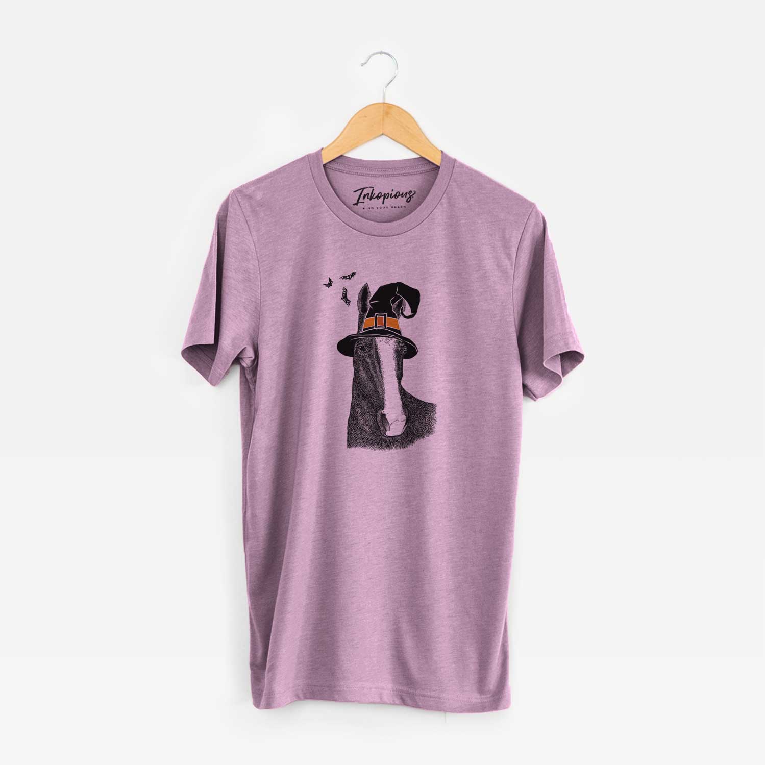 Hand-drawn sketch of Gibson the Tennessee Walking Horse wearing a witch hat on an Orchid Unisex crewneck