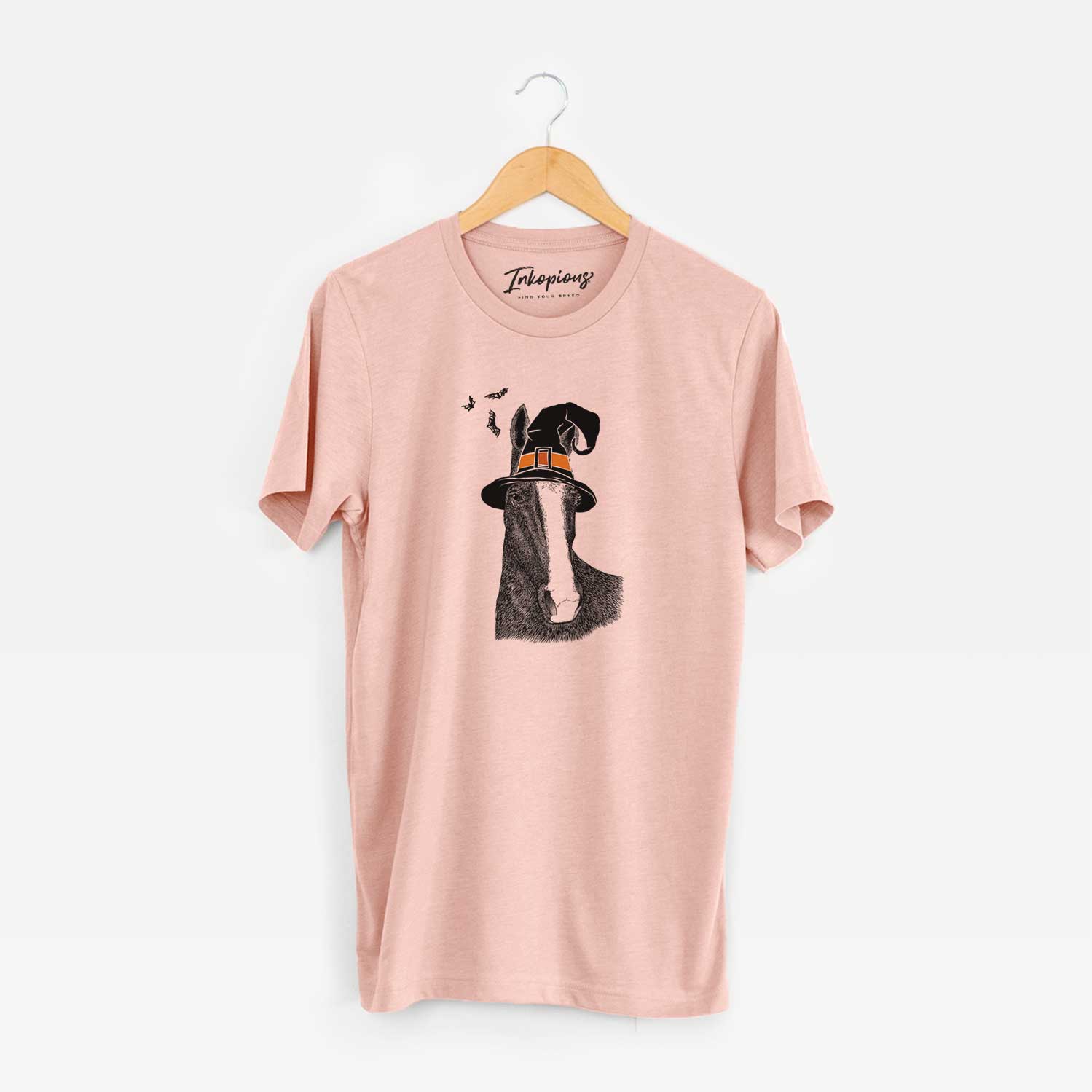 Hand-drawn sketch of Gibson the Tennessee Walking Horse wearing a witch hat on a Peach Unisex crewneck