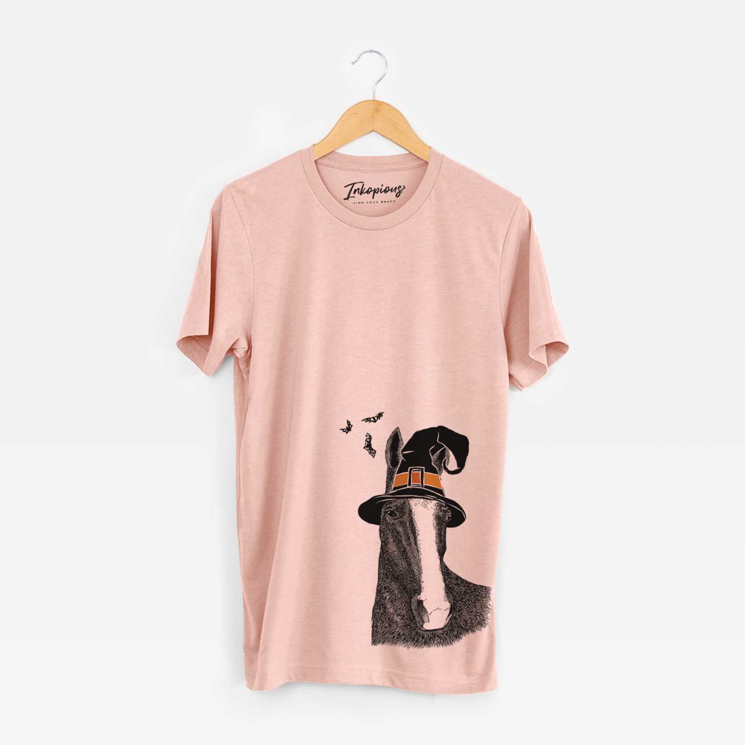 Hand-drawn sketch of Gibson the Tennessee Walking Horse wearing a witch hat on a Peach Unisex crewneck