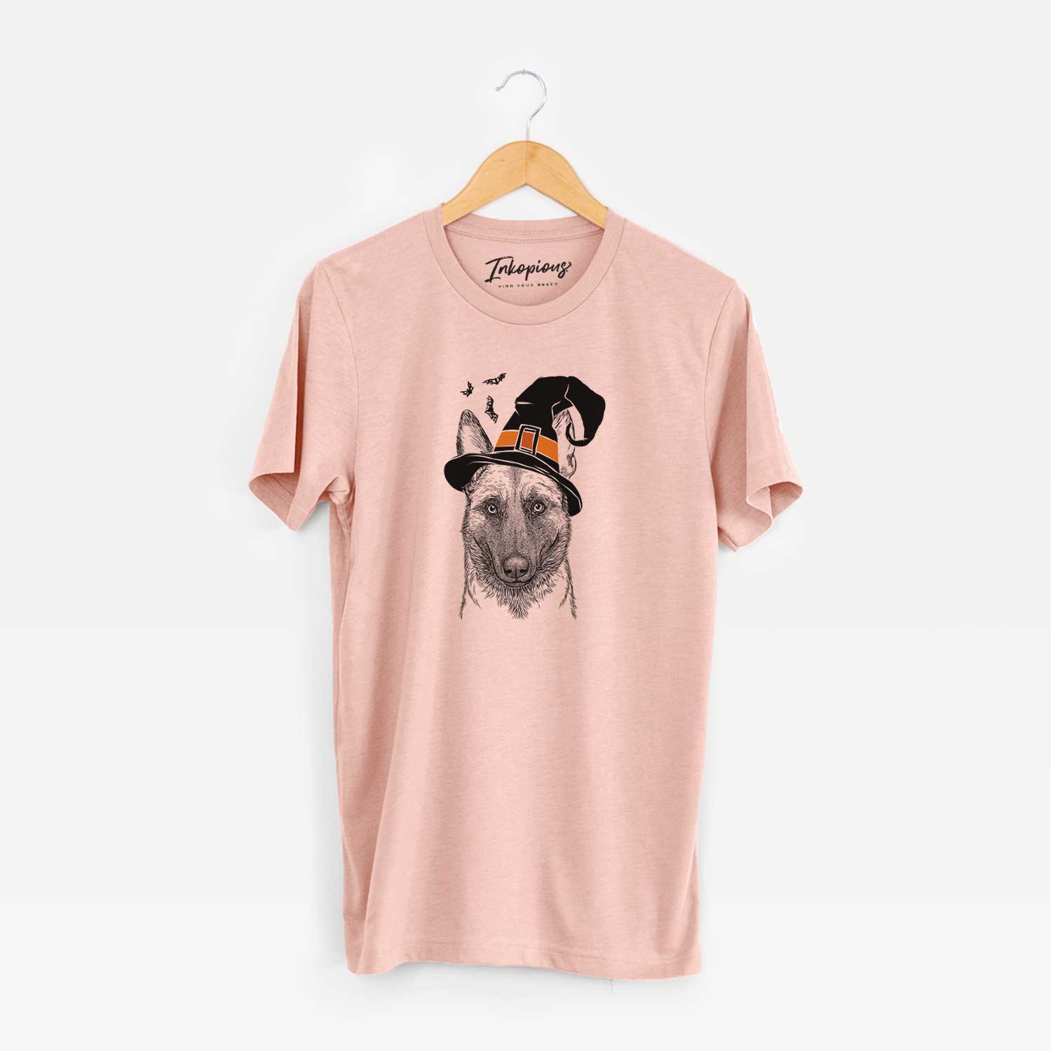 Hand-drawn sketch of Gunther the Belgian Malinois wearing a witch hat on a Peach Unisex crewneck