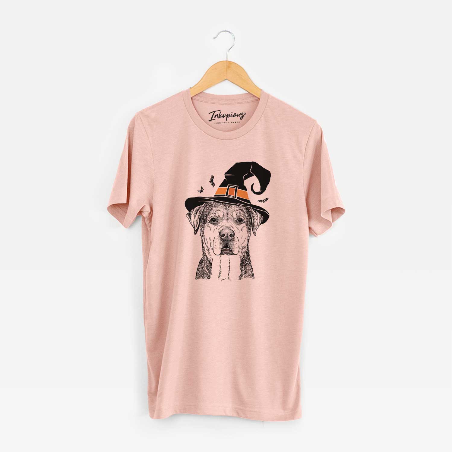Hand-drawn sketch of Gus the Rottweiler Mix wearing a witch hat on a Peach Unisex crewneck