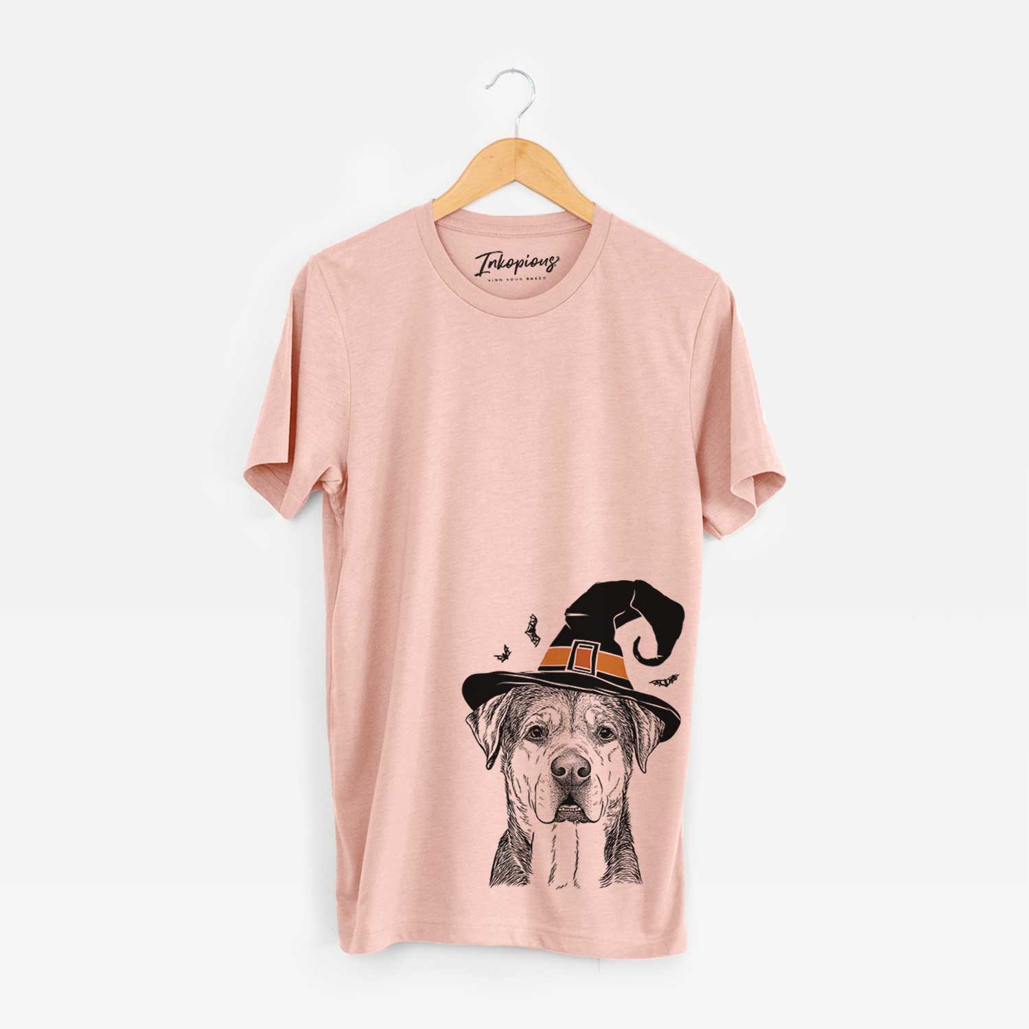 Hand-drawn sketch of Gus the Rottweiler Mix wearing a witch hat on a Peach Unisex crewneck