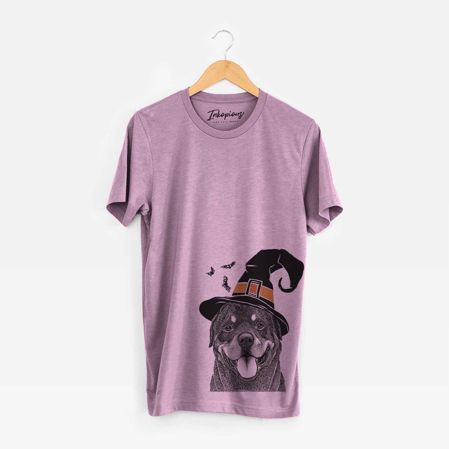 Hand-drawn sketch of Hagan the Rottweiler wearing a witch hat on an Orchid Unisex crewneck