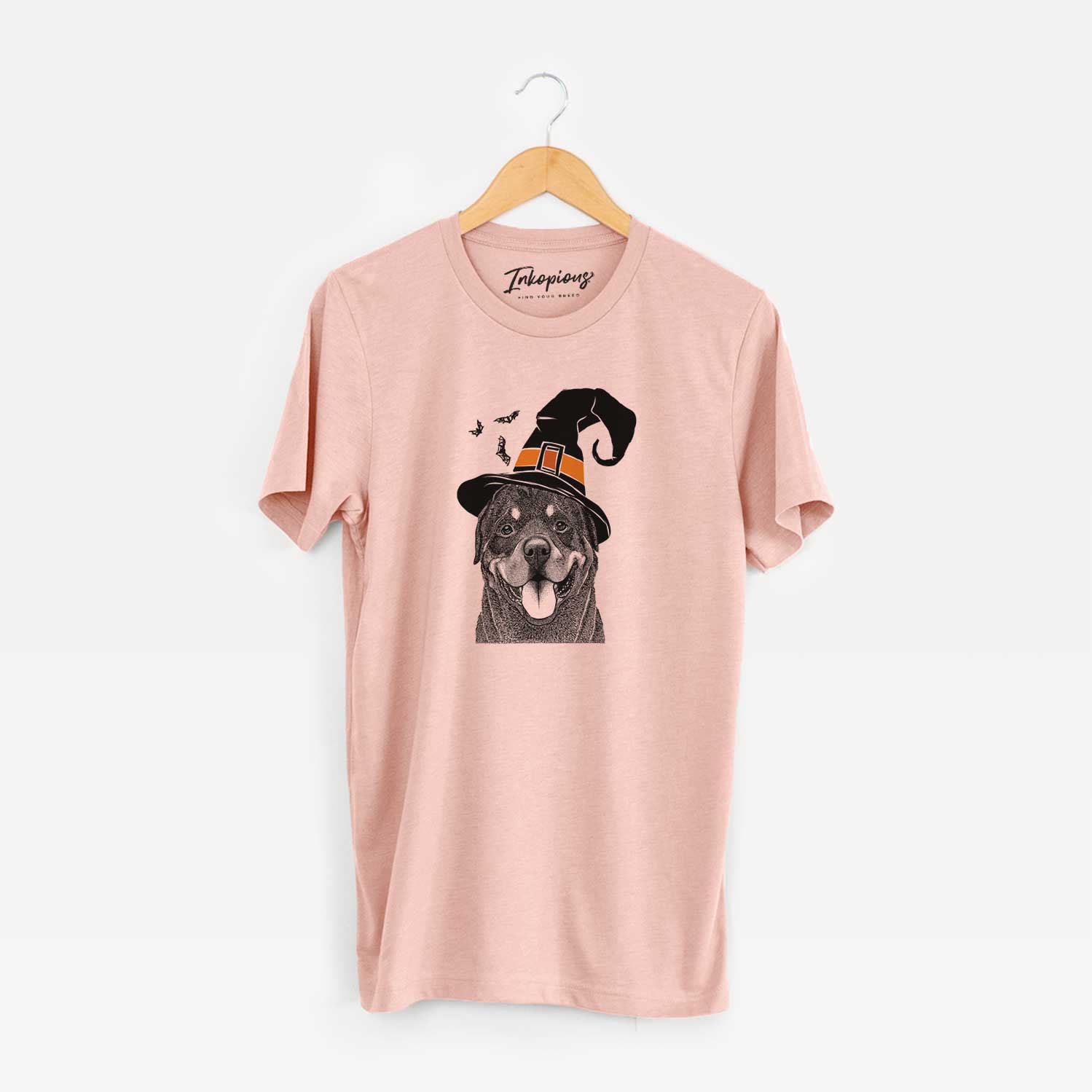 Hand-drawn sketch of Hagan the Rottweiler wearing a witch hat on a Peach Unisex crewneck