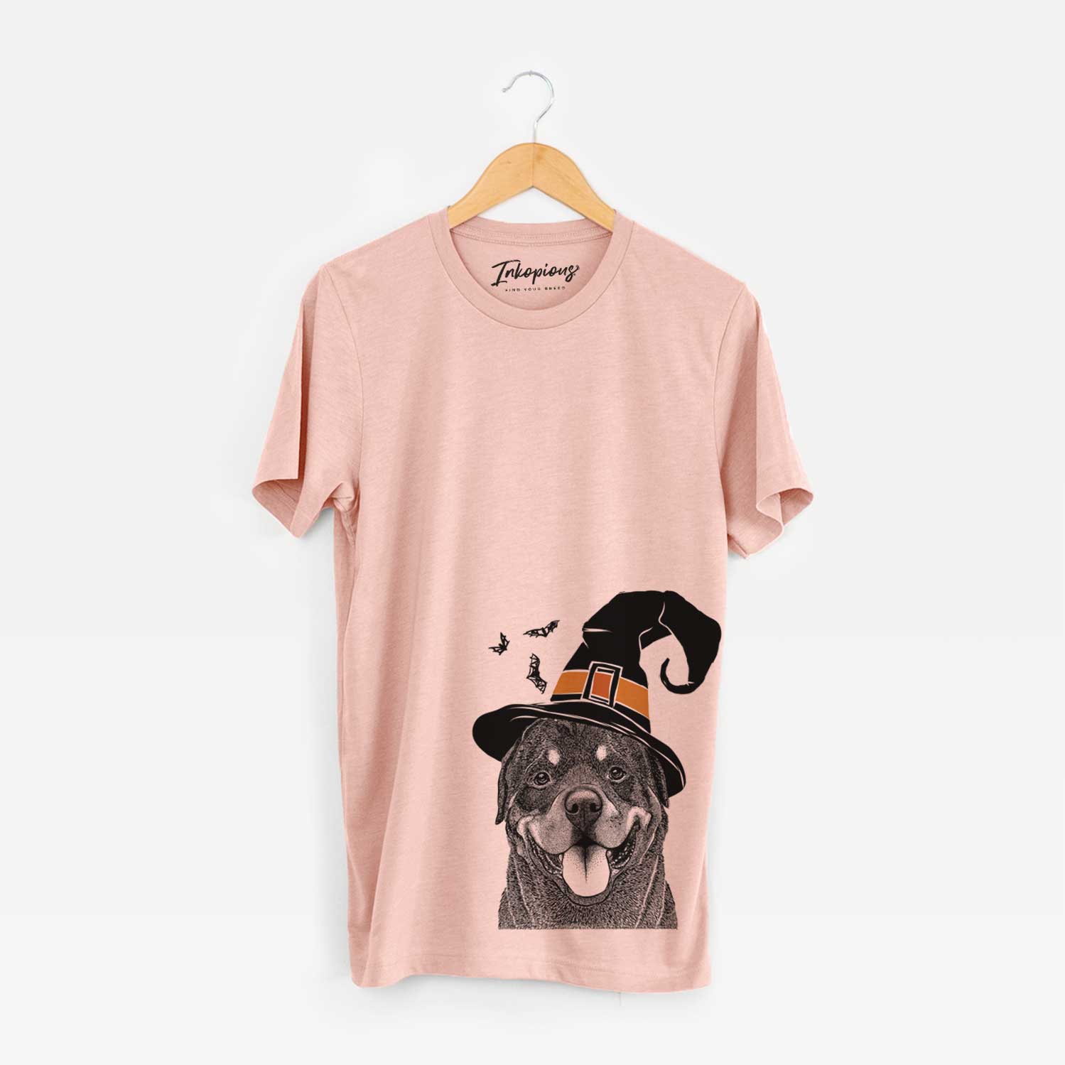 Hand-drawn sketch of Hagan the Rottweiler wearing a witch hat on a Peach Unisex crewneck
