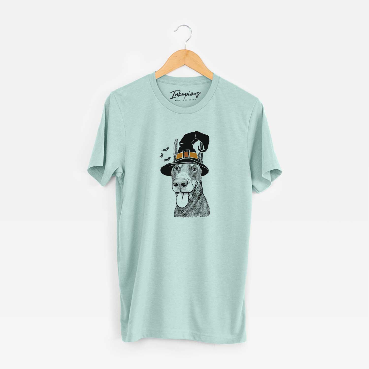 Hand-drawn sketch of Happy Sunny the Doberman Pinscher wearing a witch hat on a Heather Sage Unisex crewneck