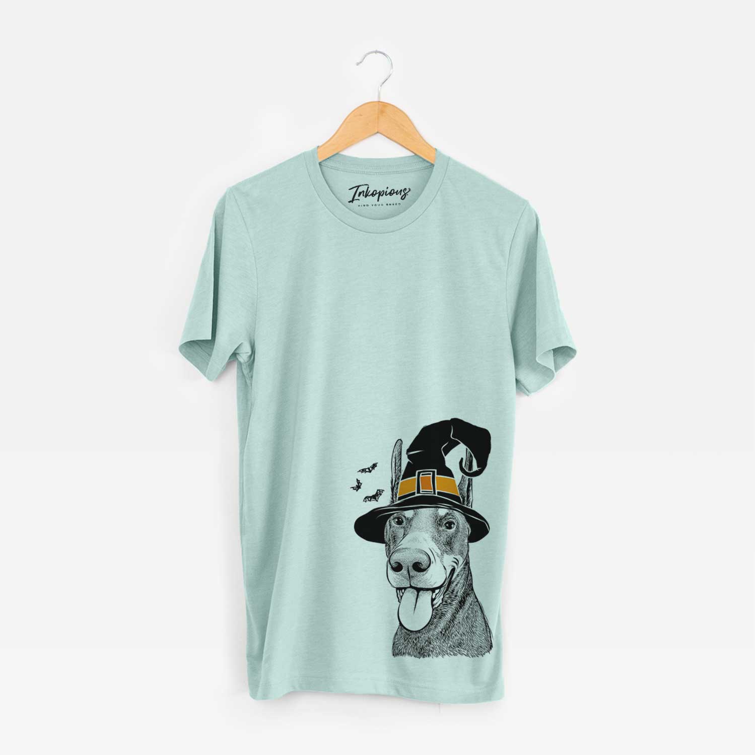 Hand-drawn sketch of Happy Sunny the Doberman Pinscher wearing a witch hat on a Heather Sage Unisex crewneck