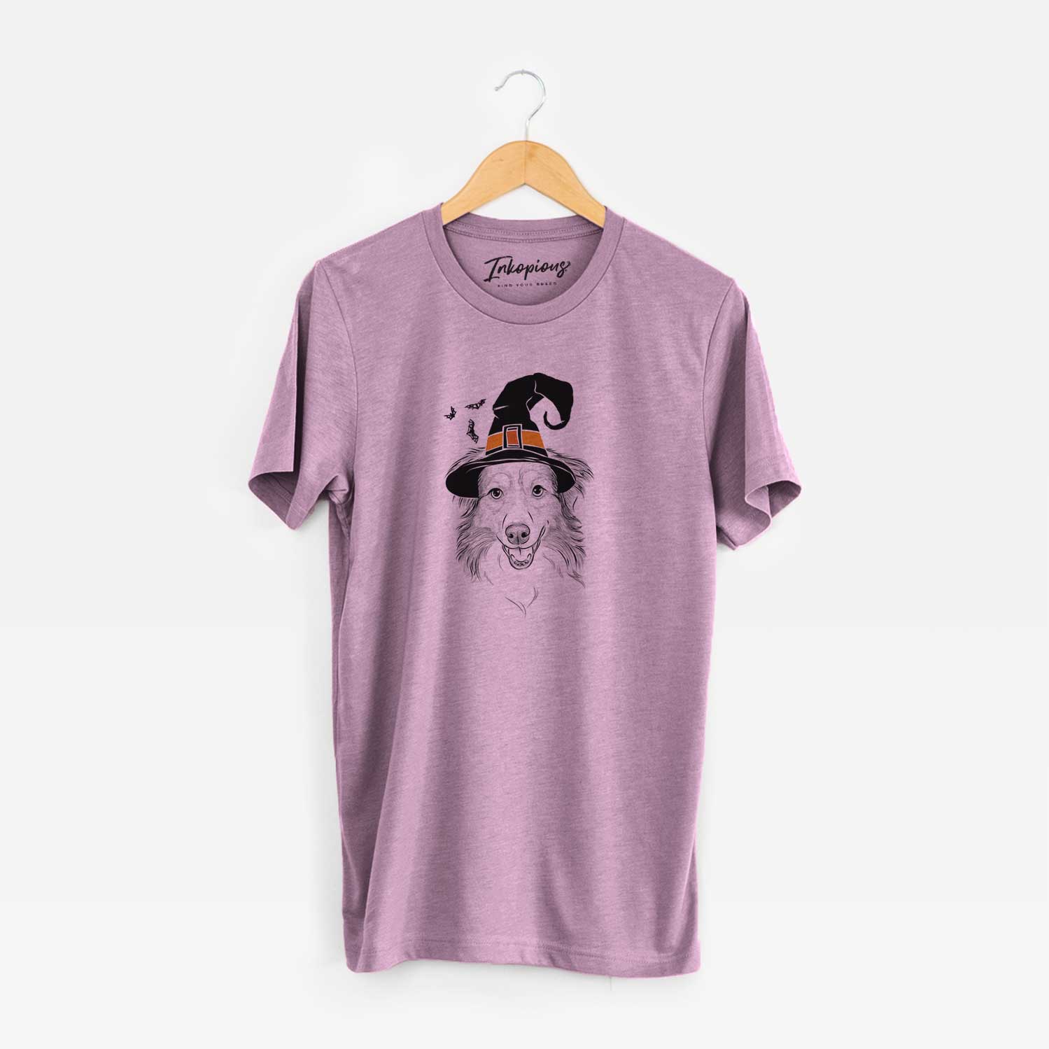 Hand-drawn sketch of Hattie the Australian Shepherd wearing a witch hat on an Orchid Unisex crewneck