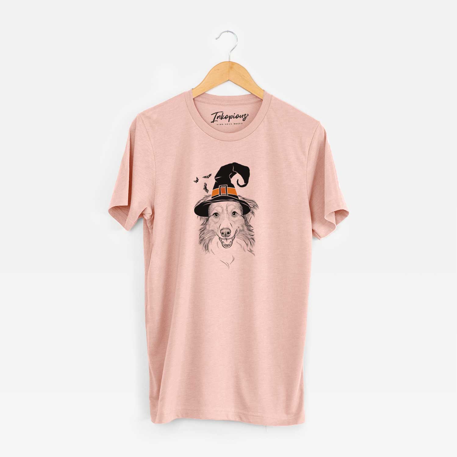 Hand-drawn sketch of Hattie the Australian Shepherd wearing a witch hat on a Peach Unisex crewneck