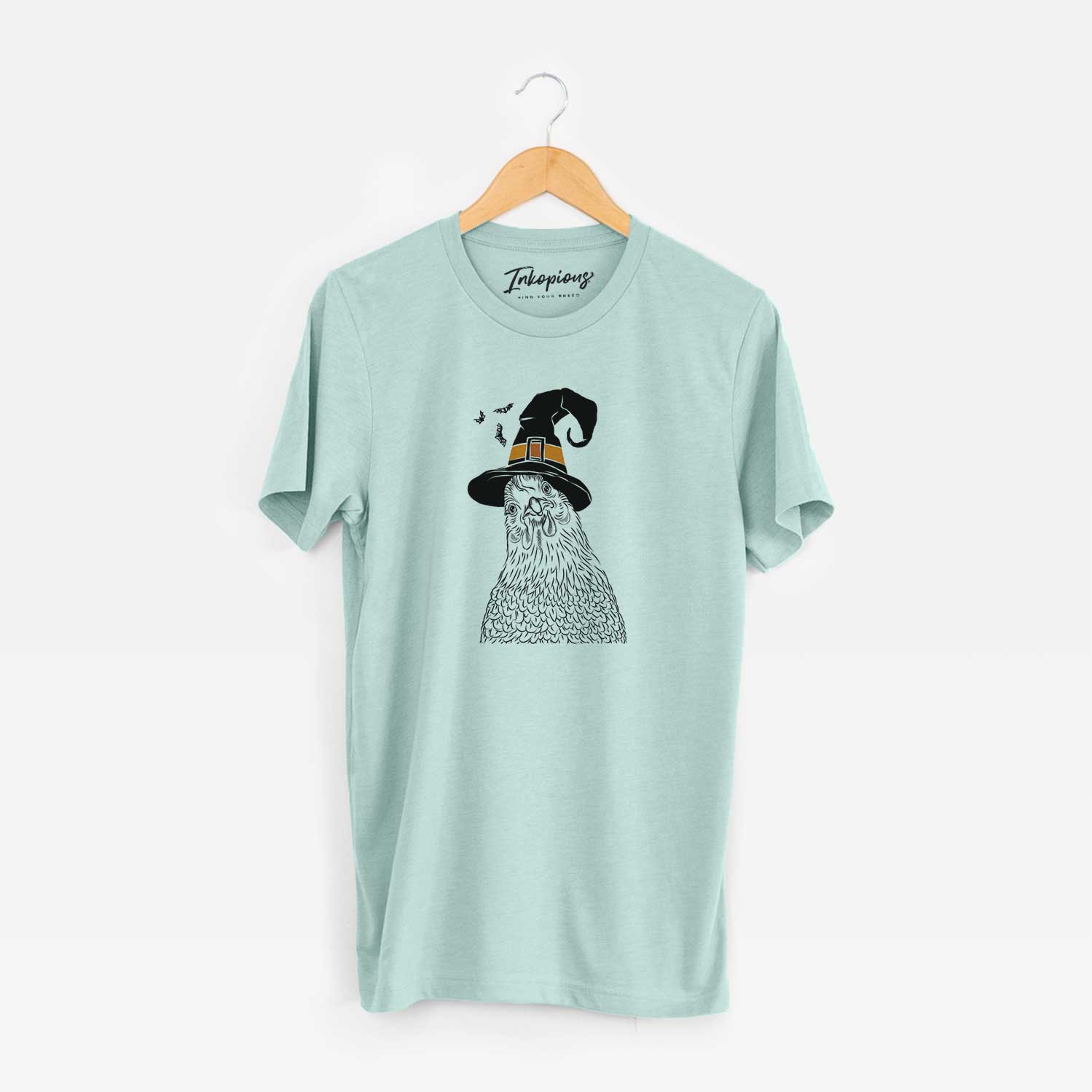 Hand-drawn sketch of Henrietta the Chicken wearing a witch hat on a Heather Sage Unisex crewneck