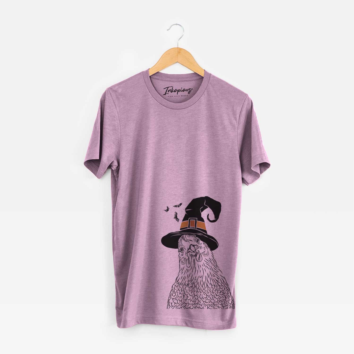 Hand-drawn sketch of Henrietta the Chicken wearing a witch hat on an Orchid Unisex crewneck