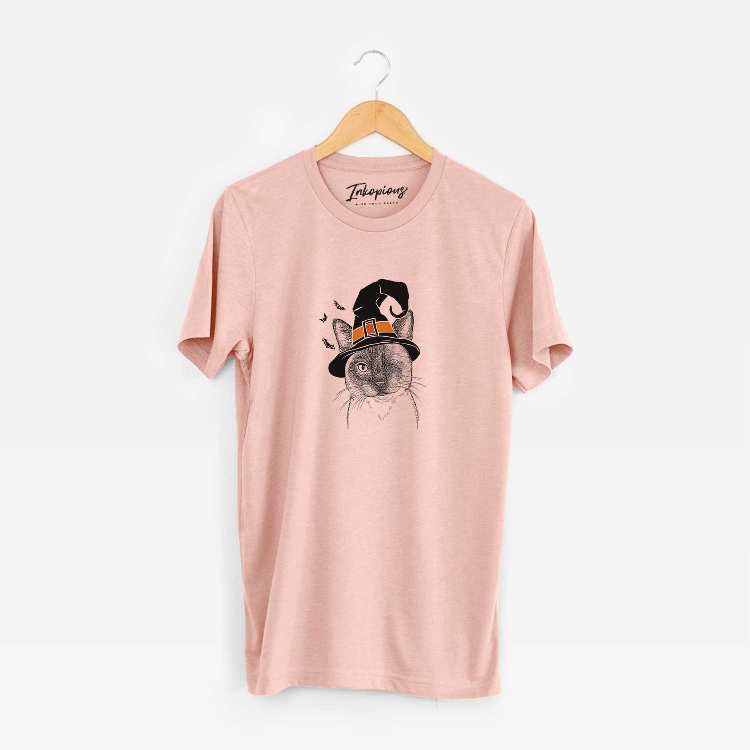 Hand-drawn sketch of Hoggle the Siamese Cat wearing a witch hat on a Peach Unisex crewneck