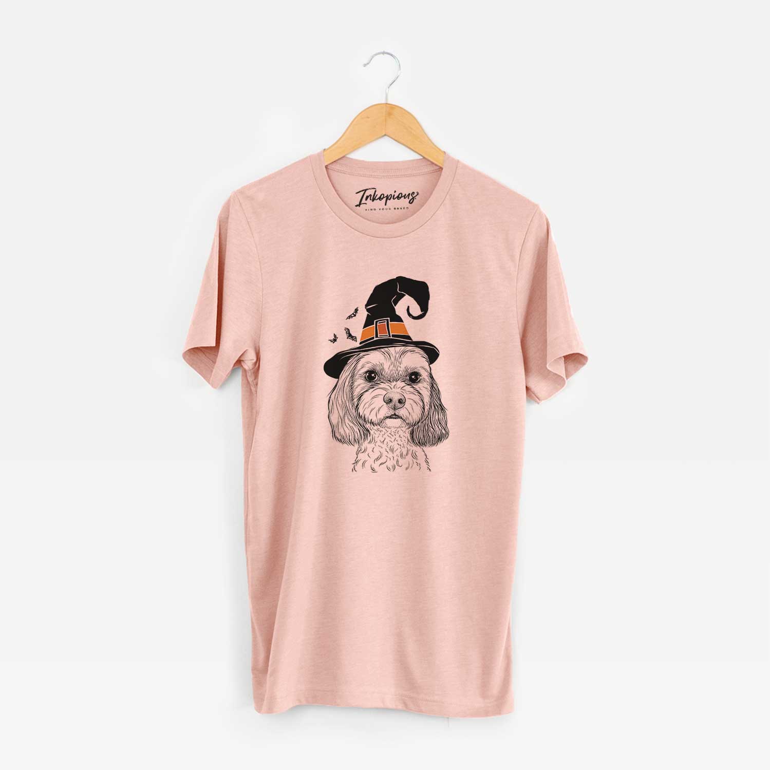 Hand-drawn sketch of Jasper Diggins the Cavapoo wearing a witch hat on a Peach Unisex crewneck