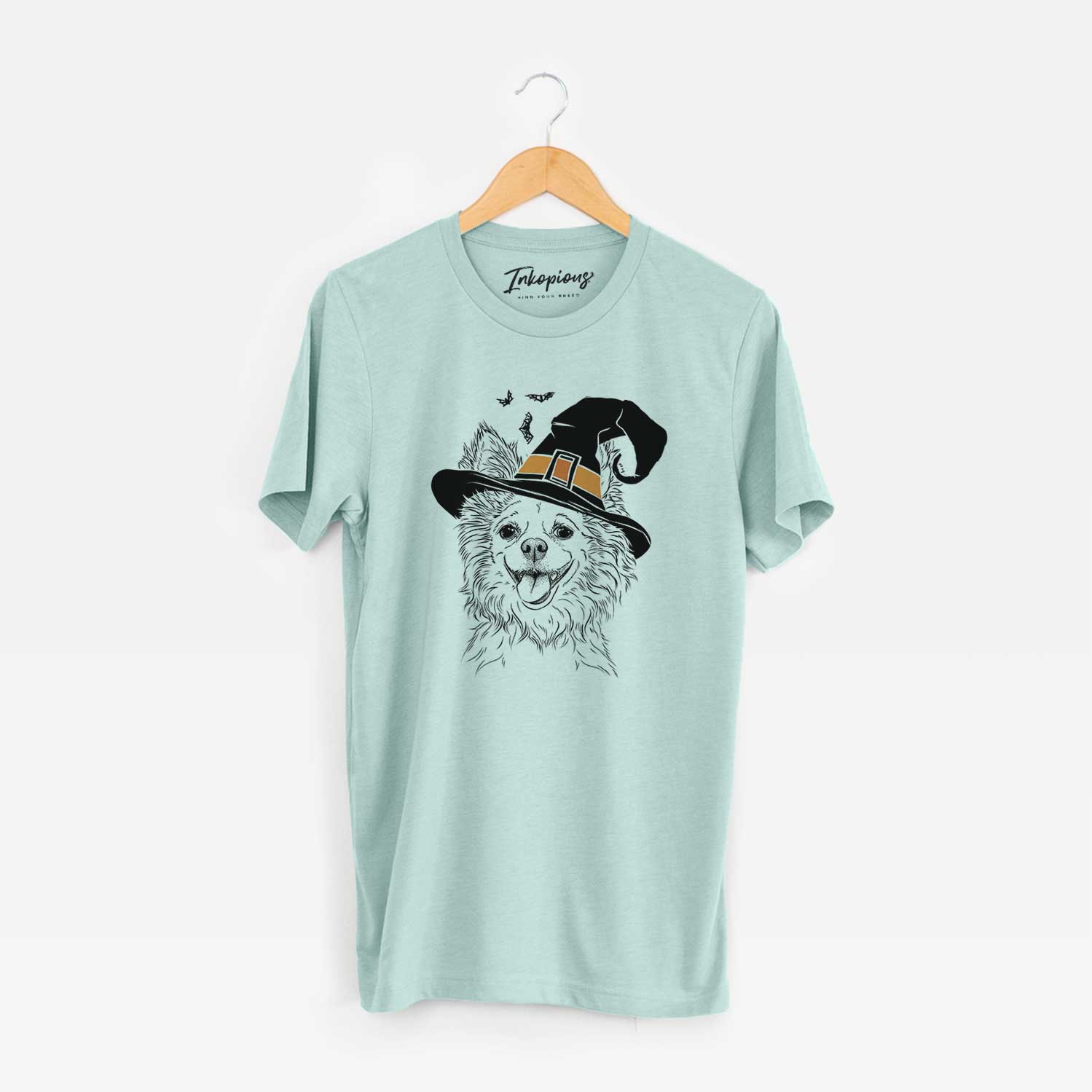 Hand-drawn sketch of Jasper the Pomchi wearing a witch hat on a Heather Sage Unisex crewneck