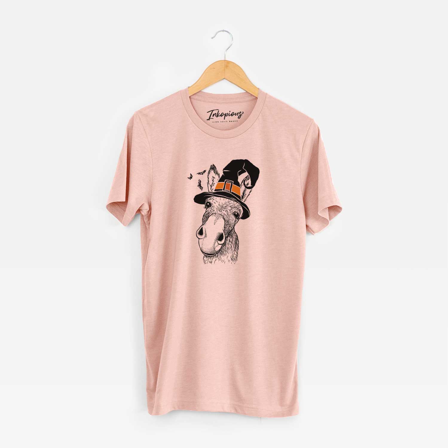 Hand-drawn sketch of Jenny the Donkey wearing a witch hat on a Peach Unisex crewneck
