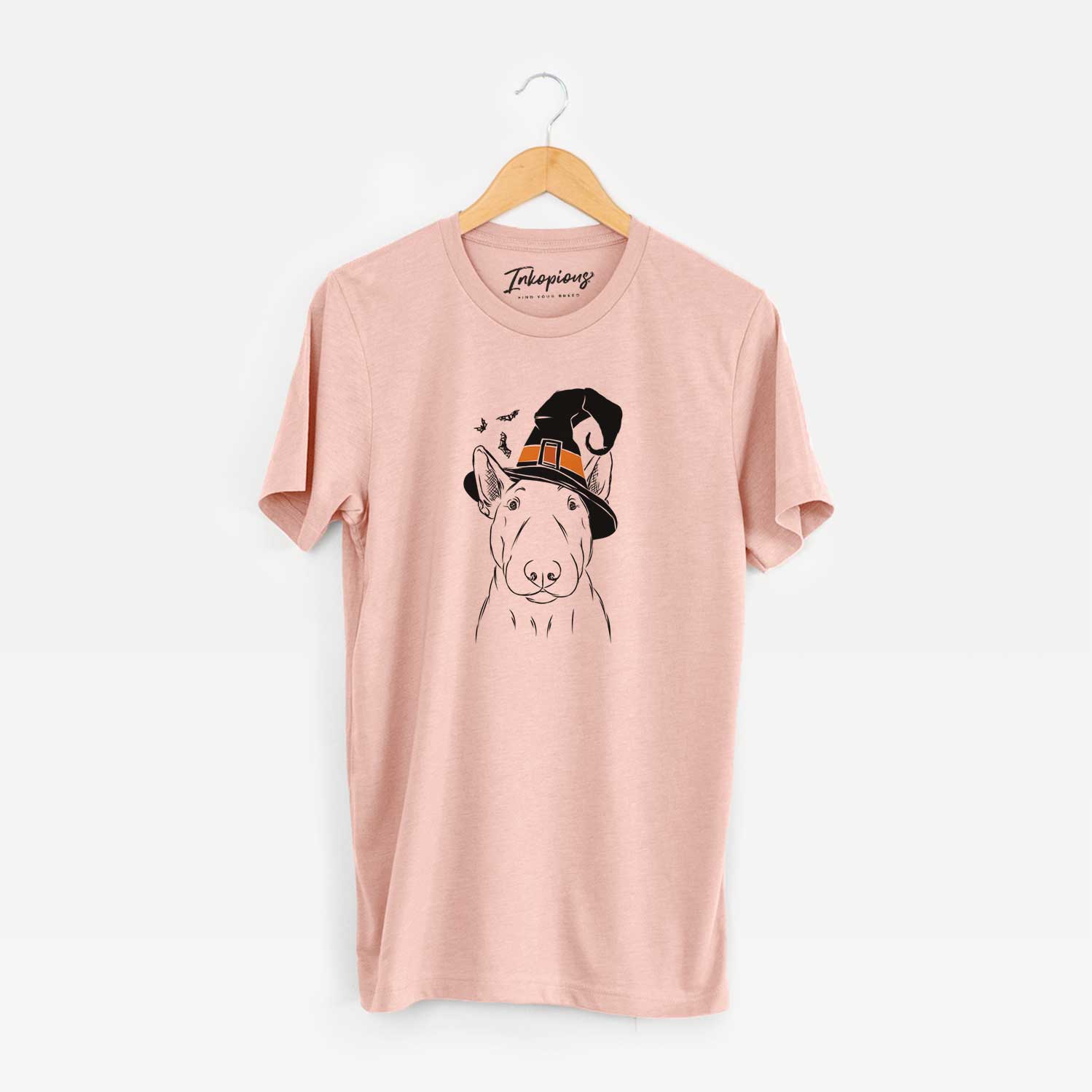 Hand-drawn sketch of Jett the Bull Terrier wearing a witch hat on a Peach Unisex crewneck