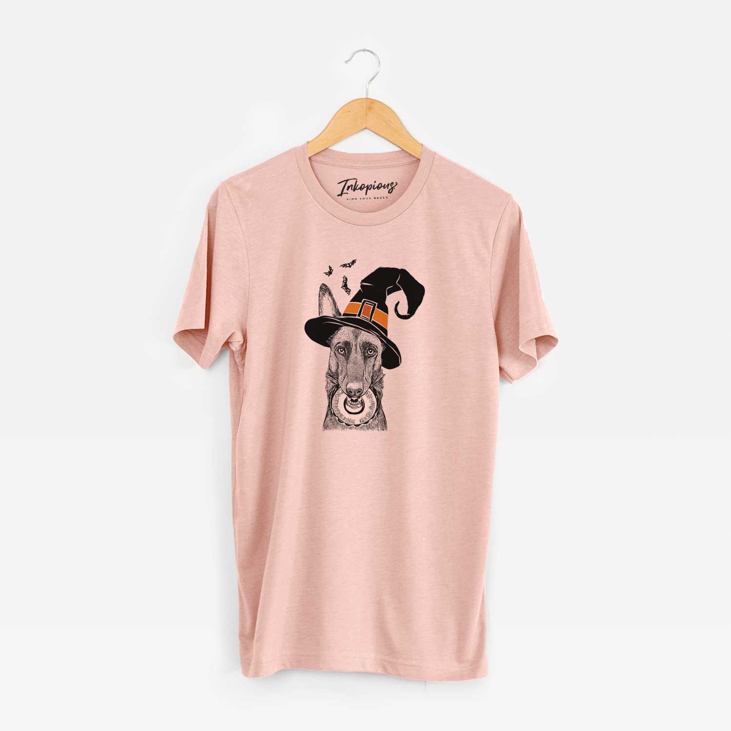 Hand-drawn sketch of Juno the Belgian Malinois wearing a witch hat on a Peach Unisex crewneck