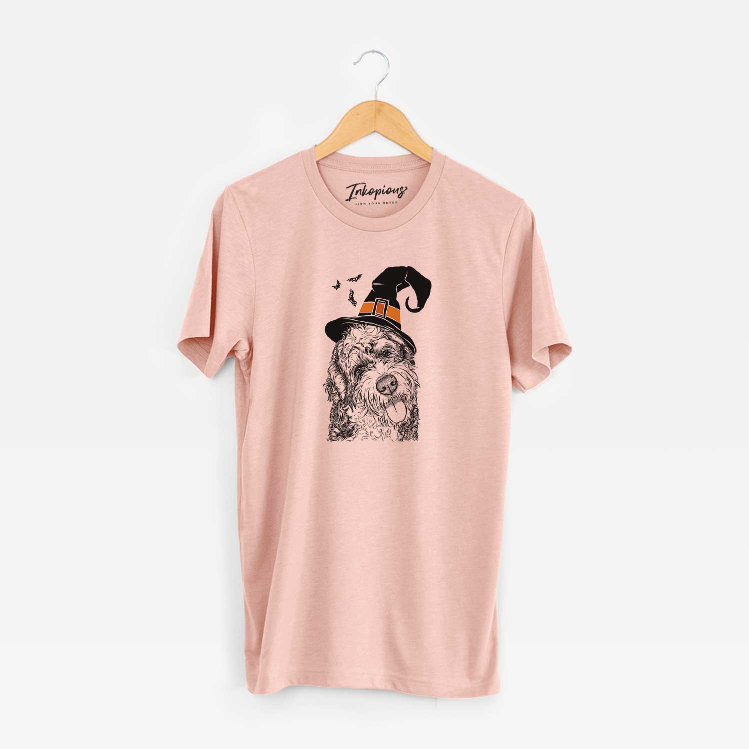 Hand-drawn sketch of Kaci the Bernedoodle wearing a witch hat on a Peach Unisex crewneck