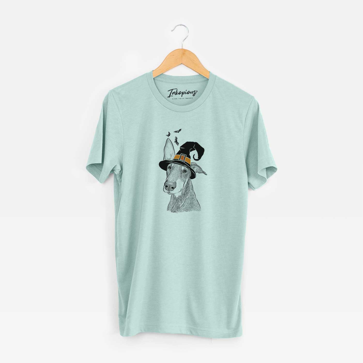 Hand-drawn sketch of Kain the Doberman Pinscher wearing a witch hat on a Heather Sage Unisex crewneck