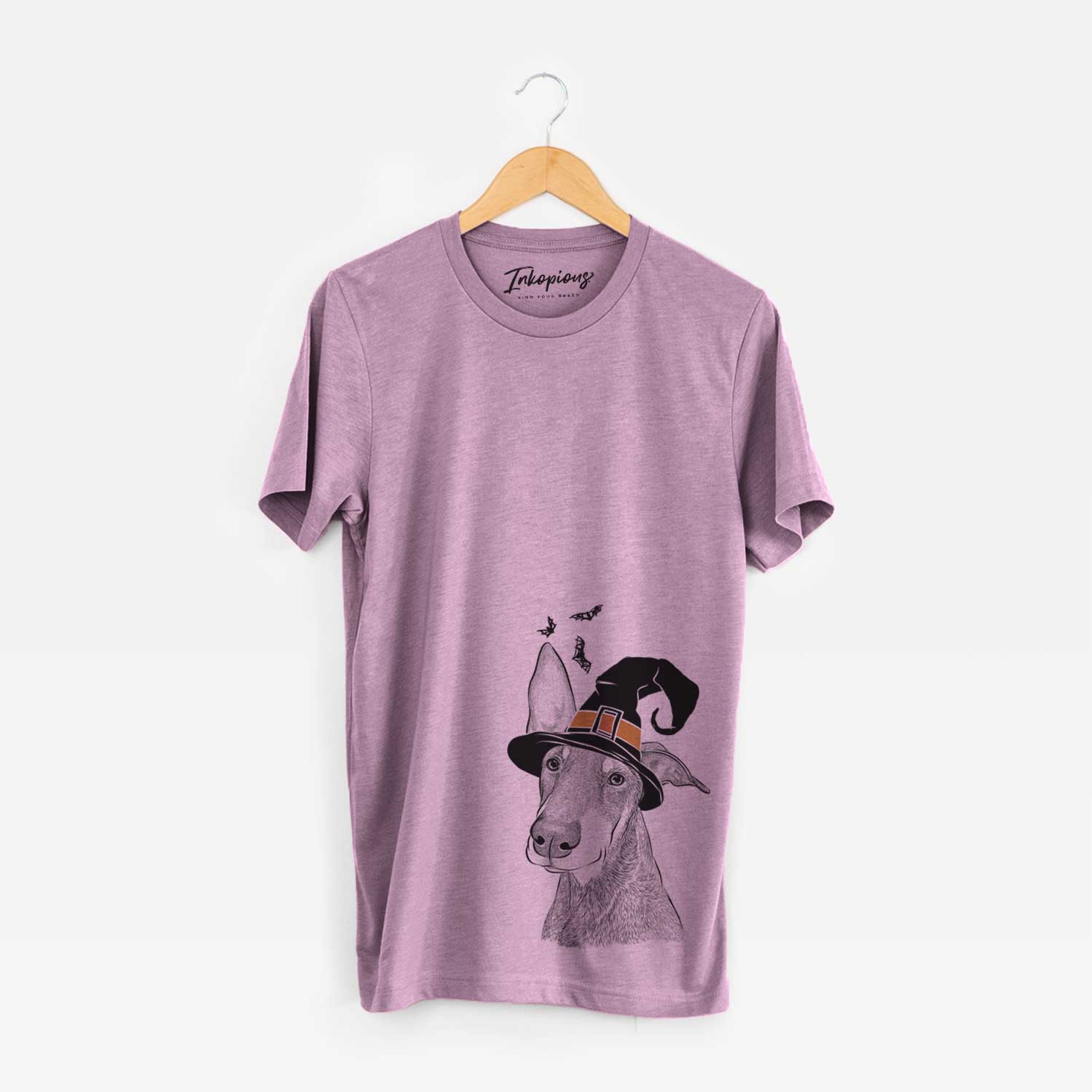 Hand-drawn sketch of Kain the Doberman Pinscher wearing a witch hat on an Orchid Unisex crewneck