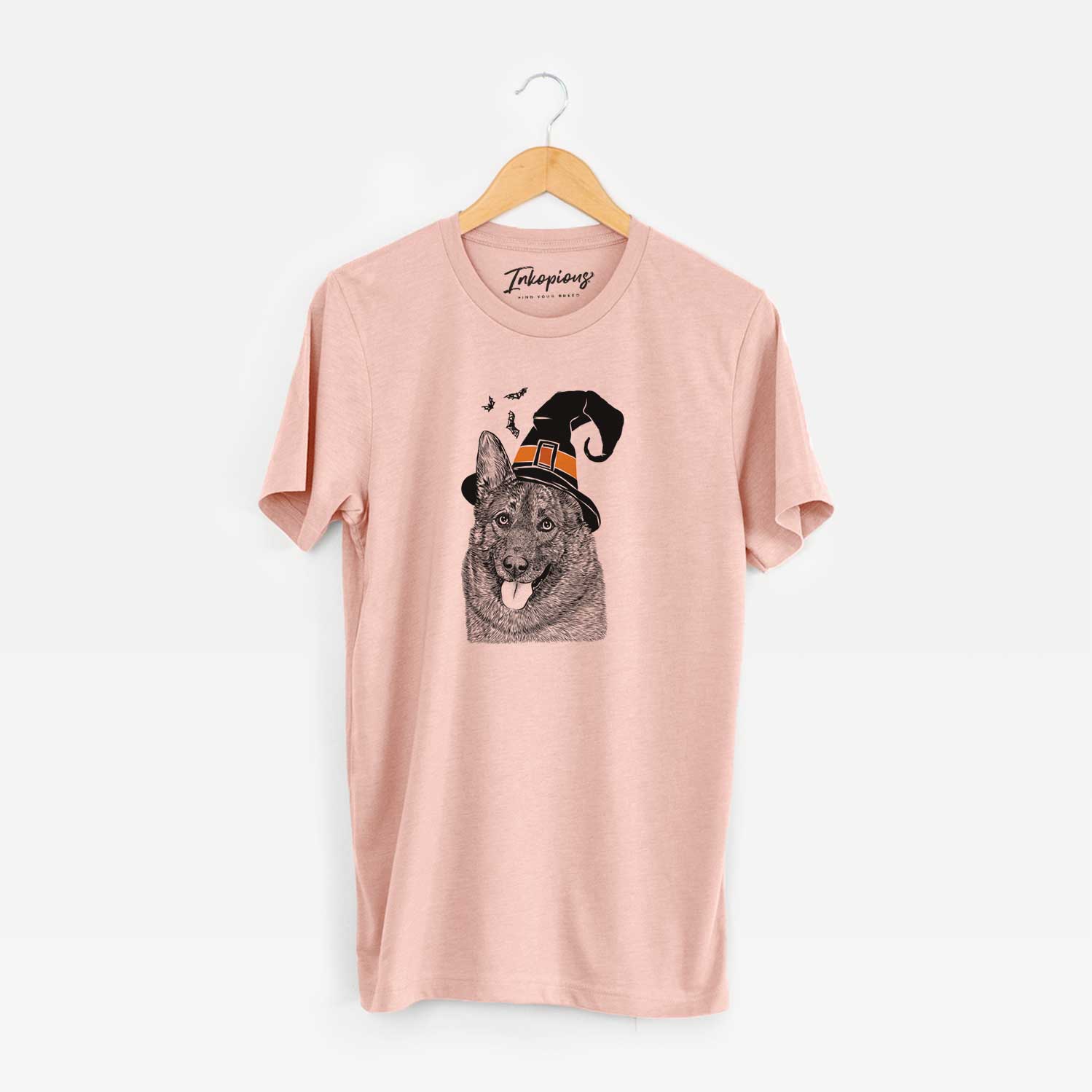 Hand-drawn sketch of Kasia the Norwegian Elkhound wearing a witch hat on a Peach Unisex crewneck
