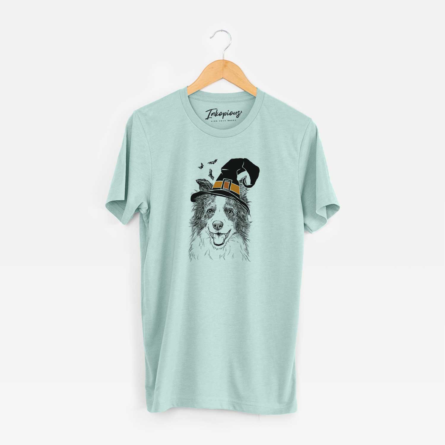 Hand-drawn sketch of Kylee the Border Collie wearing a witch hat on a Heather Sage Unisex crewneck
