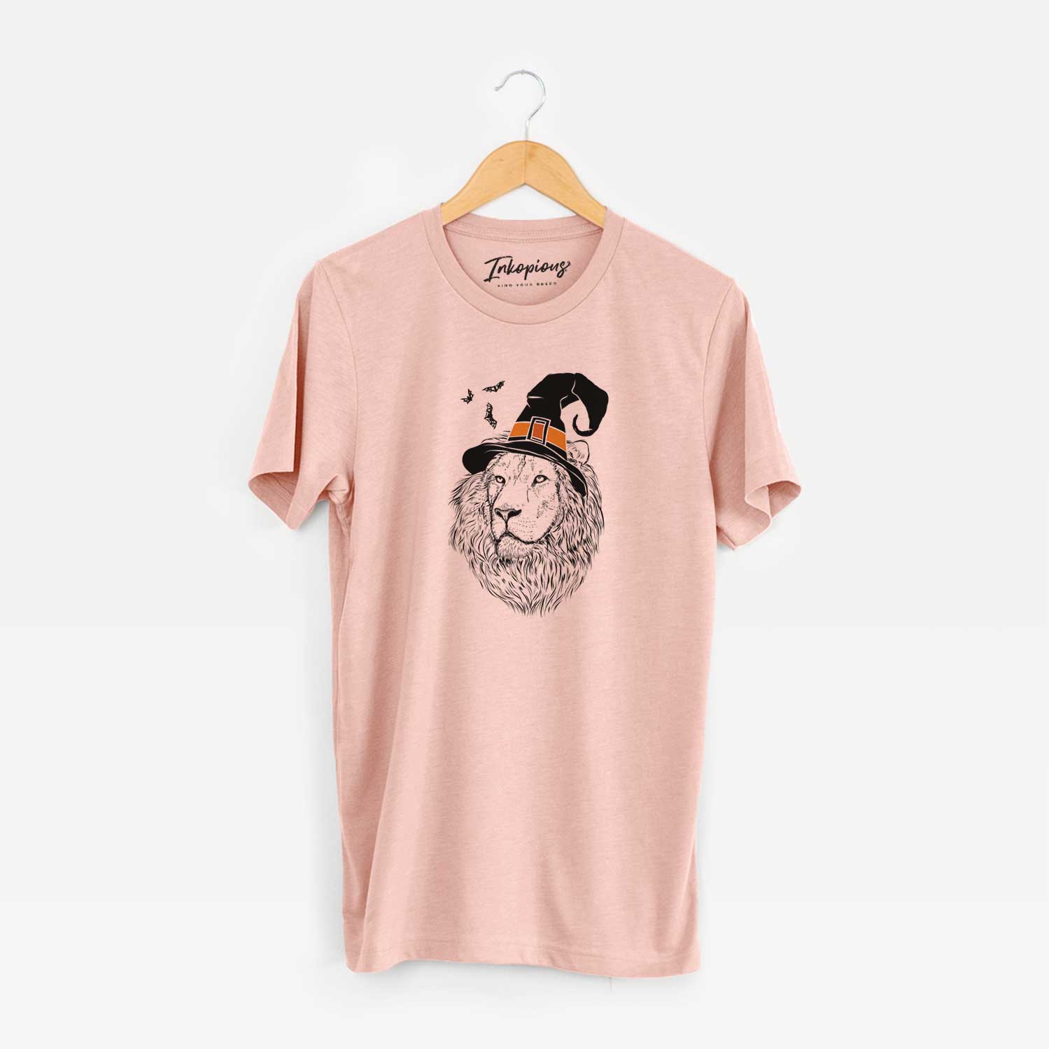 Hand-drawn sketch of Lenny the Lion wearing a witch hat on a Peach Unisex crewneck