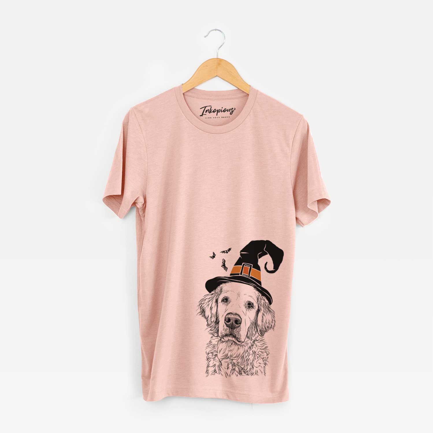 Hand-drawn sketch of Loganator the Golden Retriever wearing a witch hat on a Peach Unisex crewneck