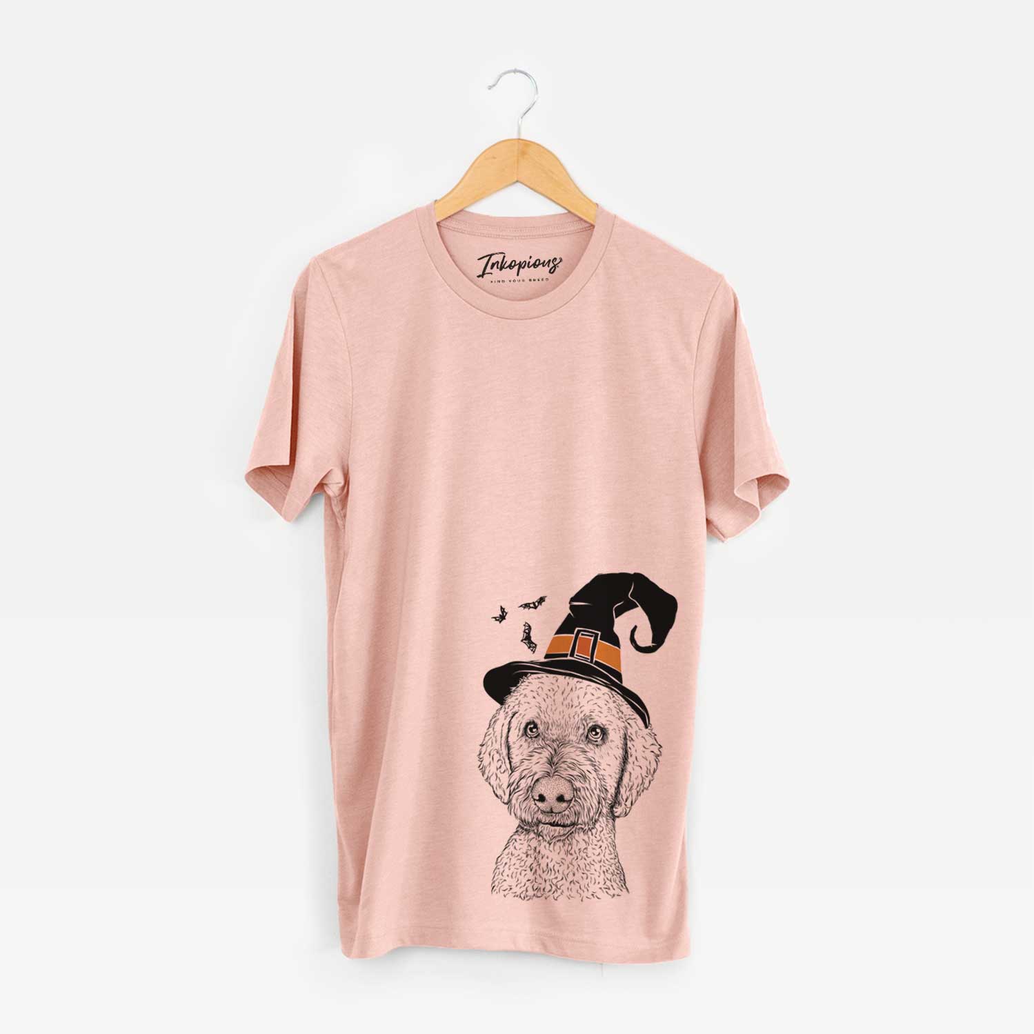 Hand-drawn sketch of Lucy Boo the Goldendoodle wearing a witch hat on a Peach Unisex crewneck