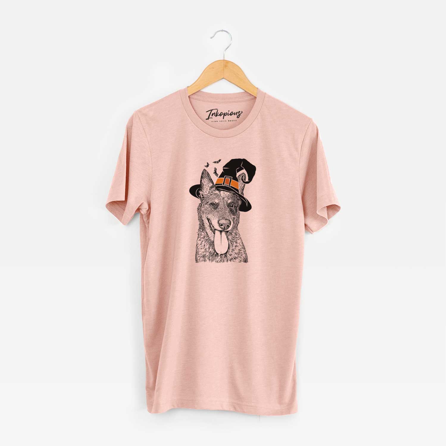 Hand-drawn sketch of Madison the Blue Heeler wearing a witch hat on a Peach Unisex crewneck