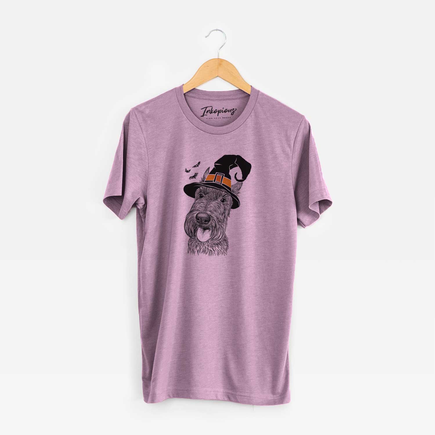 Hand-drawn sketch of Magnus the Scottish Terrier wearing a witch hat on an Orchid Unisex crewneck