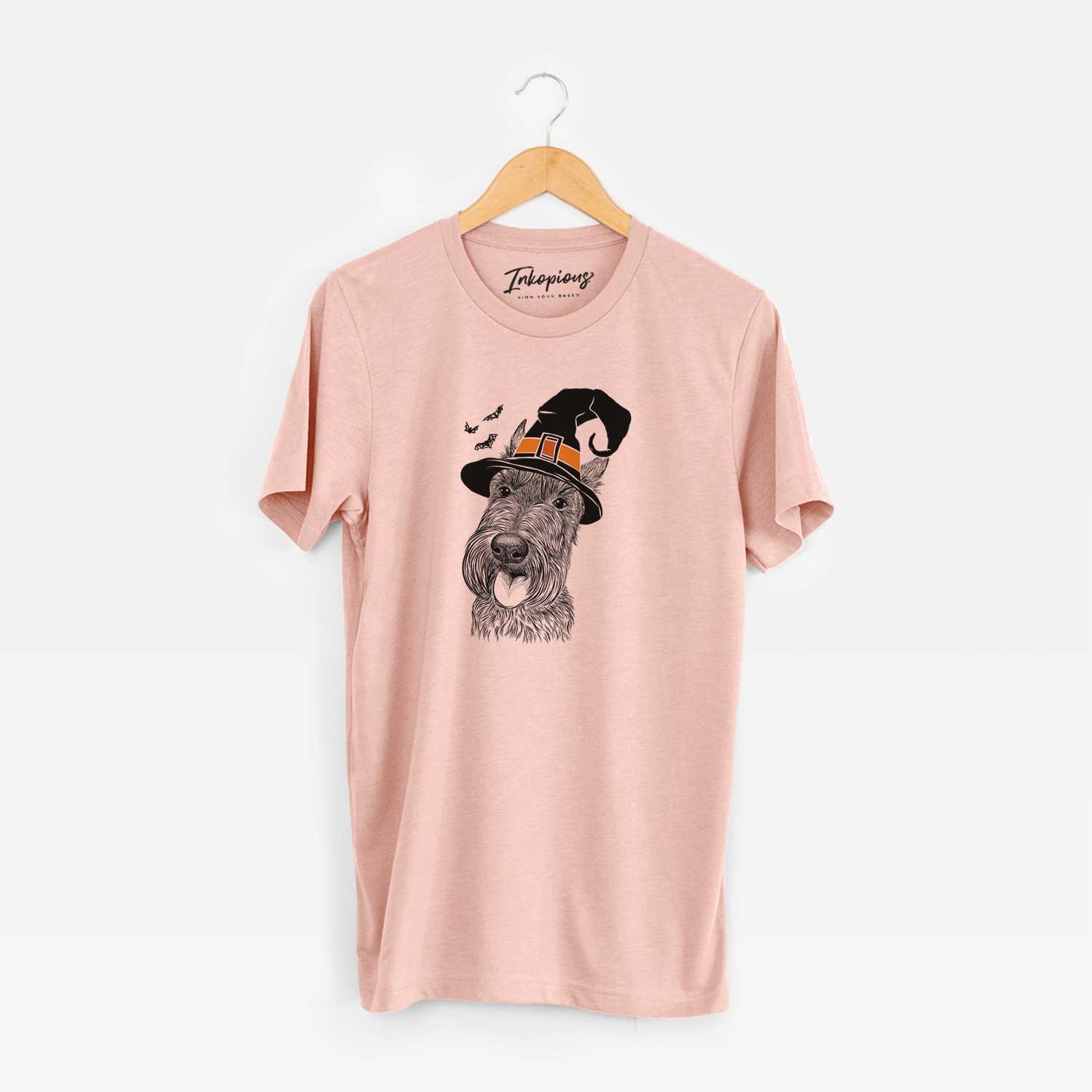 Hand-drawn sketch of Magnus the Scottish Terrier wearing a witch hat on a Peach Unisex crewneck