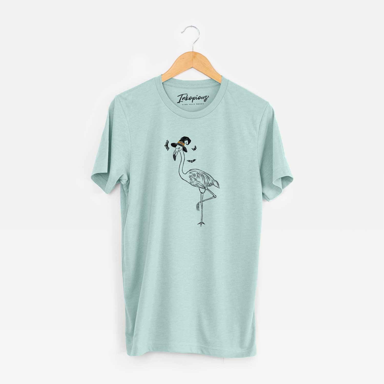 Hand-drawn sketch of Mango the Flamingo wearing a witch hat on a Heather Sage Unisex crewneck