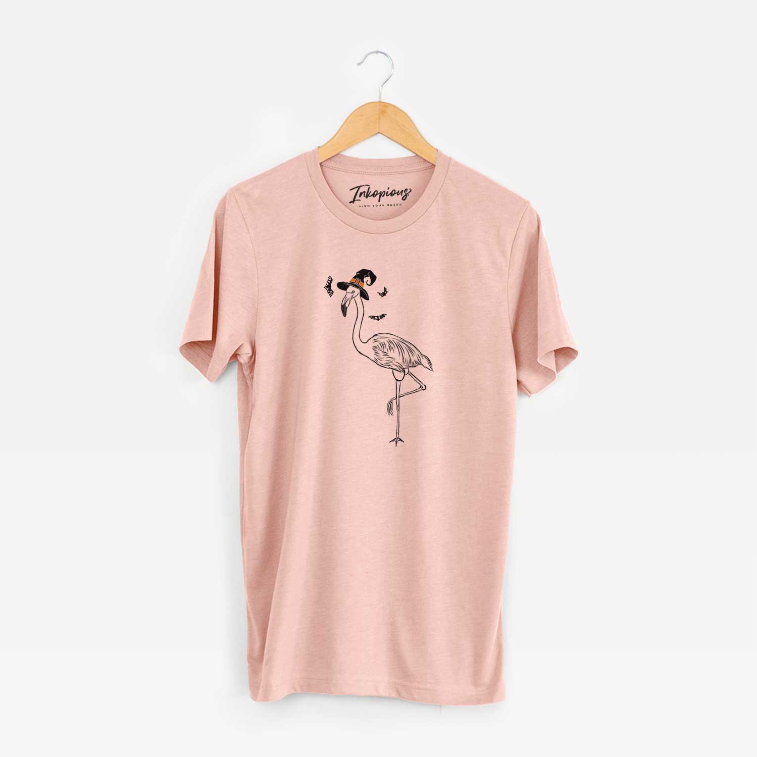 Hand-drawn sketch of Mango the Flamingo wearing a witch hat on a Peach Unisex crewneck
