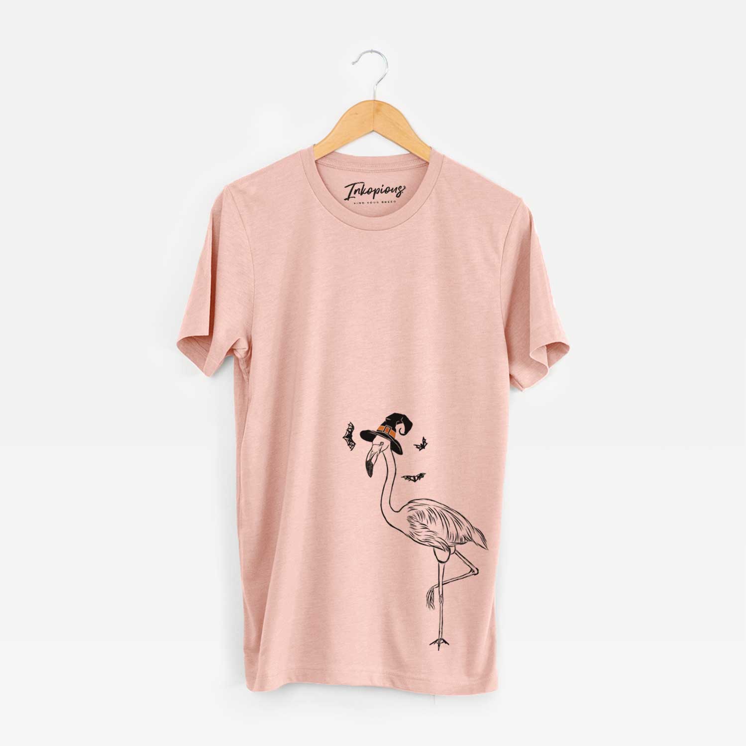 Hand-drawn sketch of Mango the Flamingo wearing a witch hat on a Peach Unisex crewneck