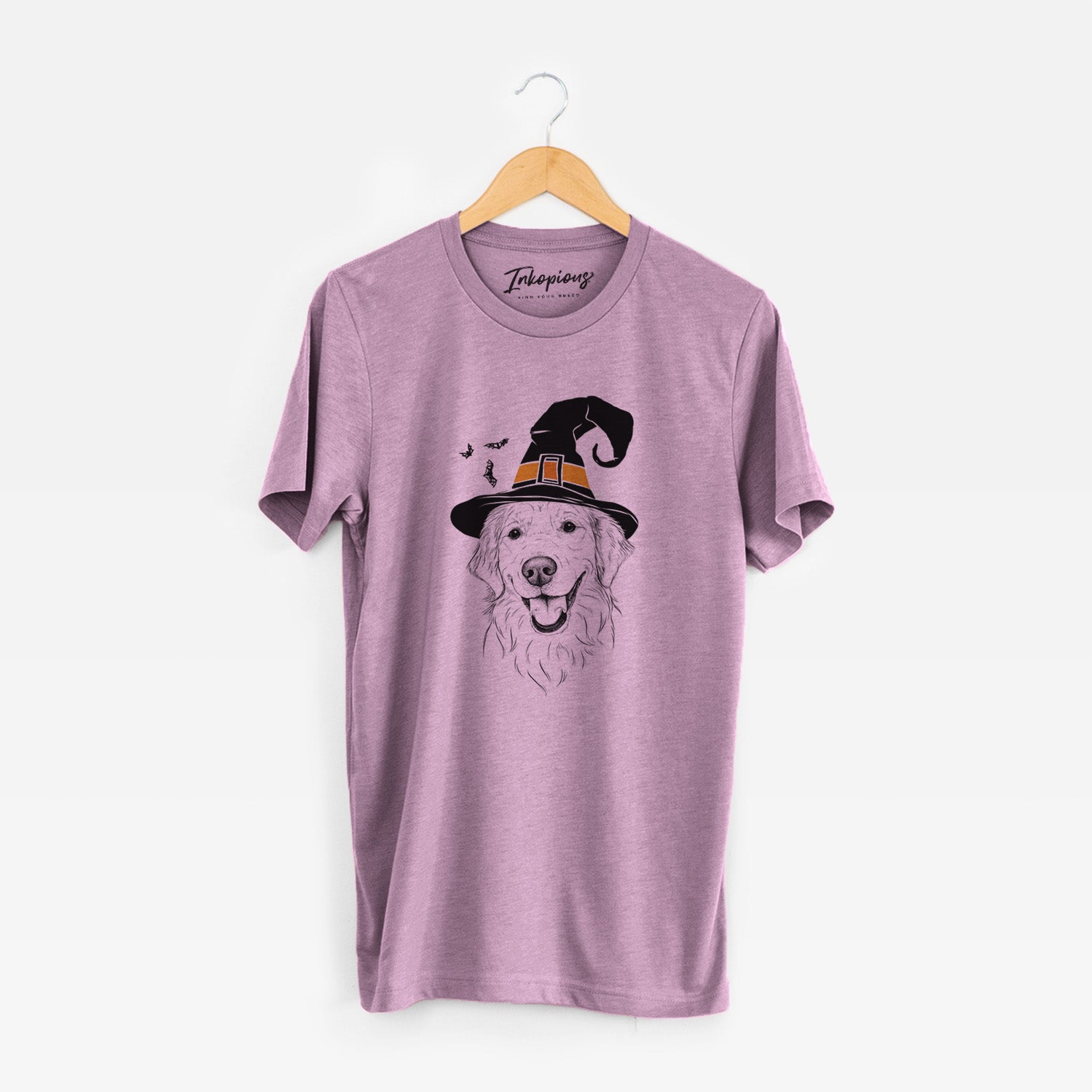 Hand-drawn sketch of Maple the Golden Retriever wearing a witch hat on an Orchid Unisex crewneck