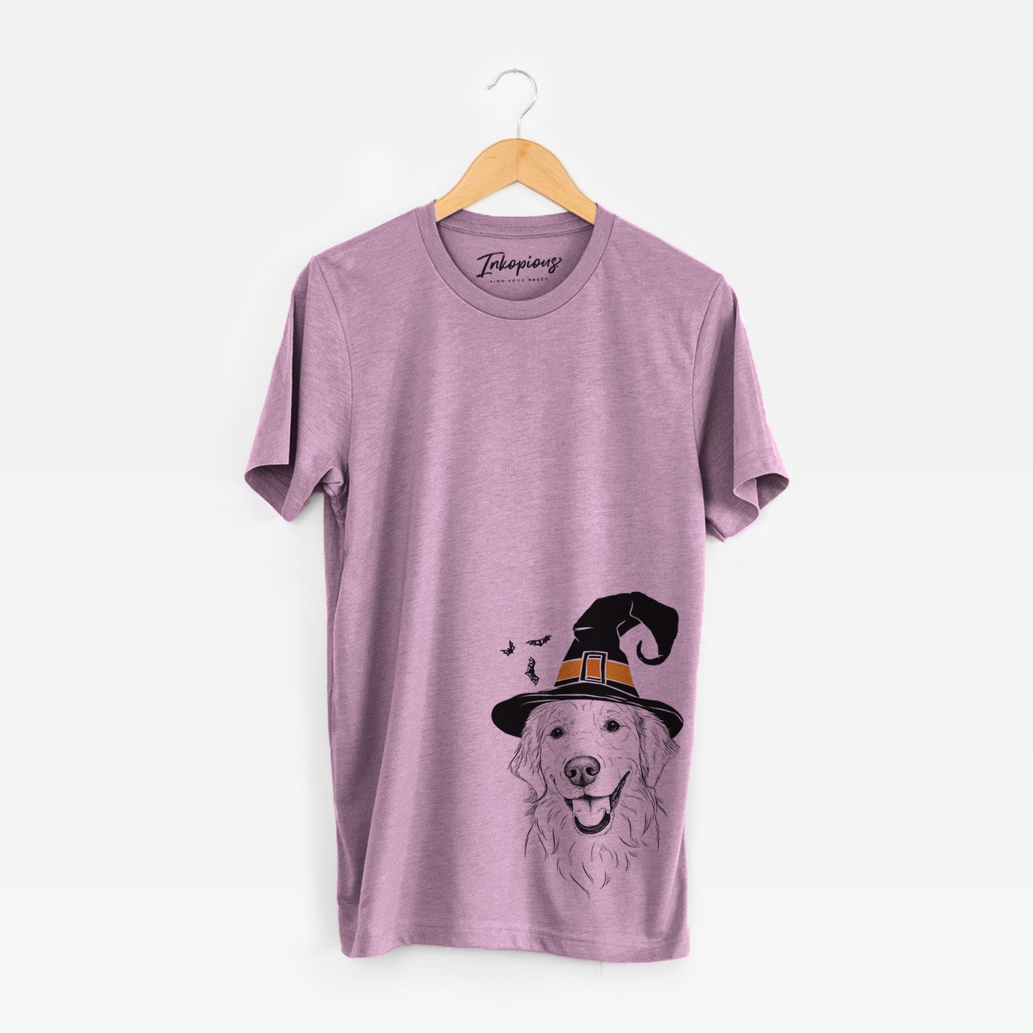 Hand-drawn sketch of Maple the Golden Retriever wearing a witch hat on an Orchid Unisex crewneck