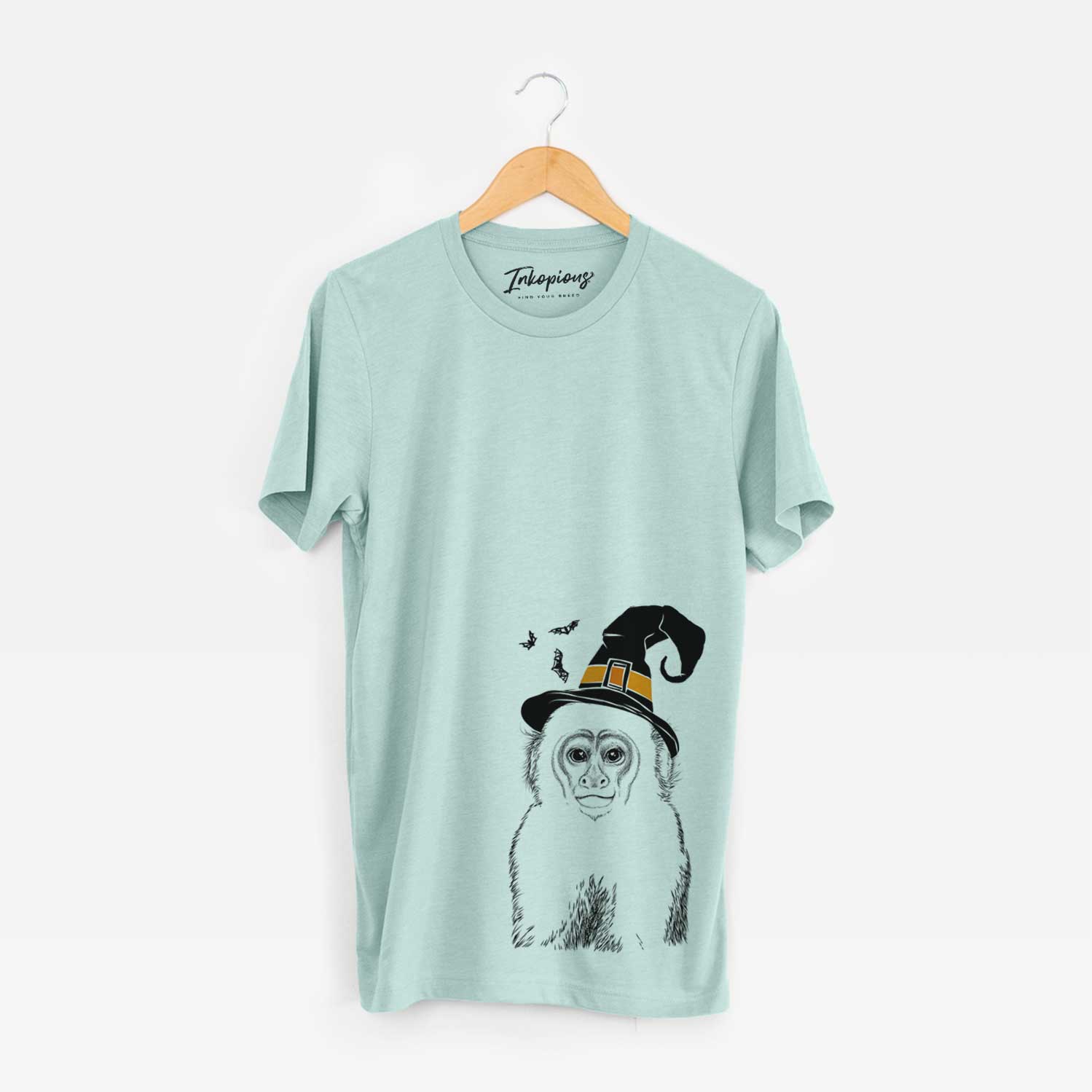 Hand-drawn sketch of Marcel the Capuchin Monkey wearing a witch hat on a Heather Sage Unisex crewneck